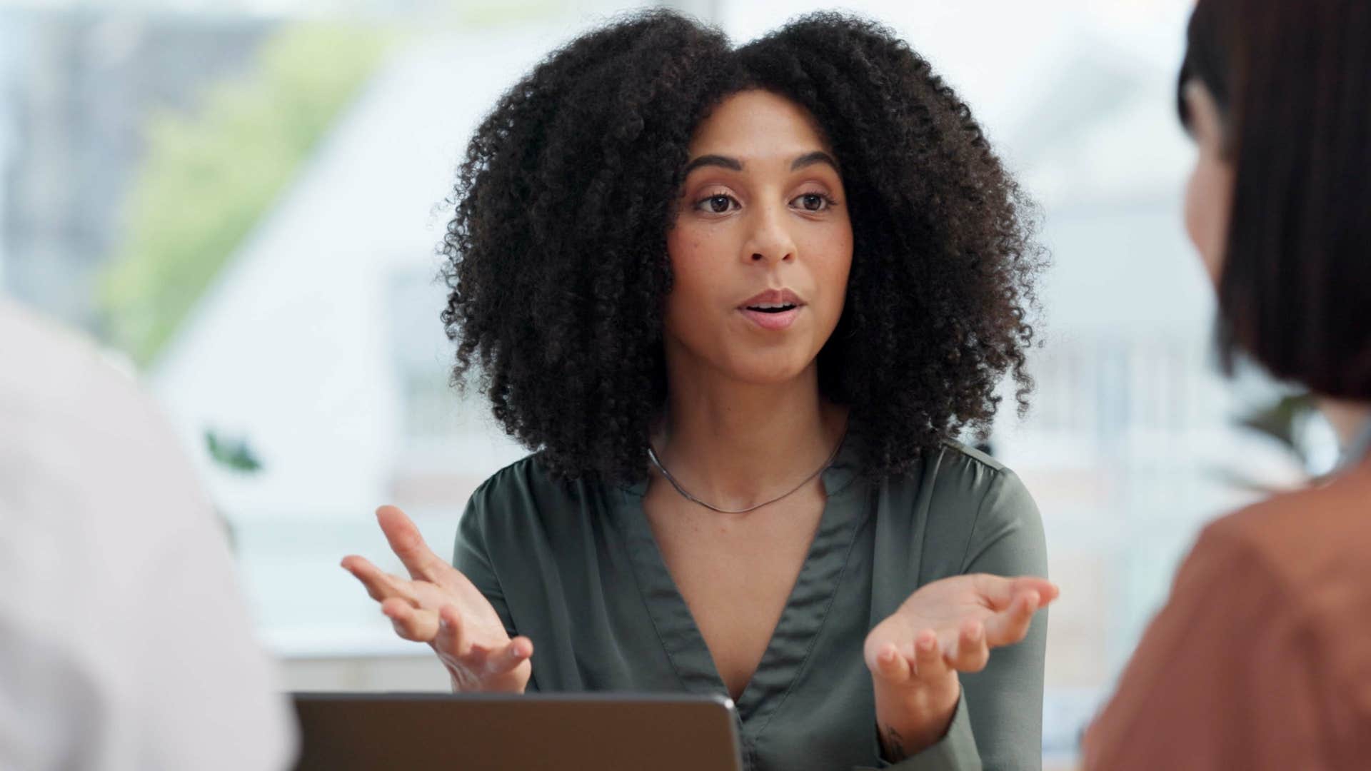 woman explaining herself to colleagues keeping her word