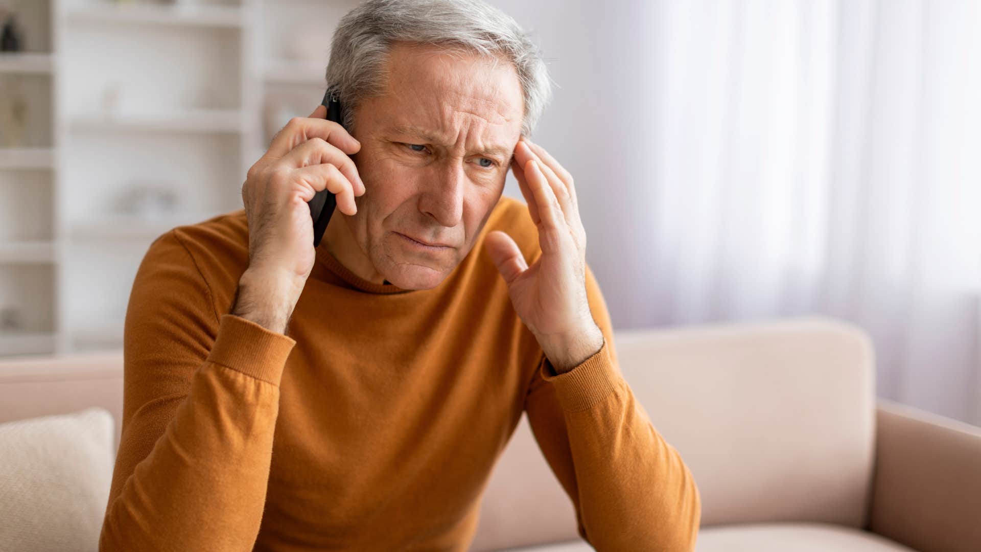 Man talking to his child who blames their parents for everything on the phone.