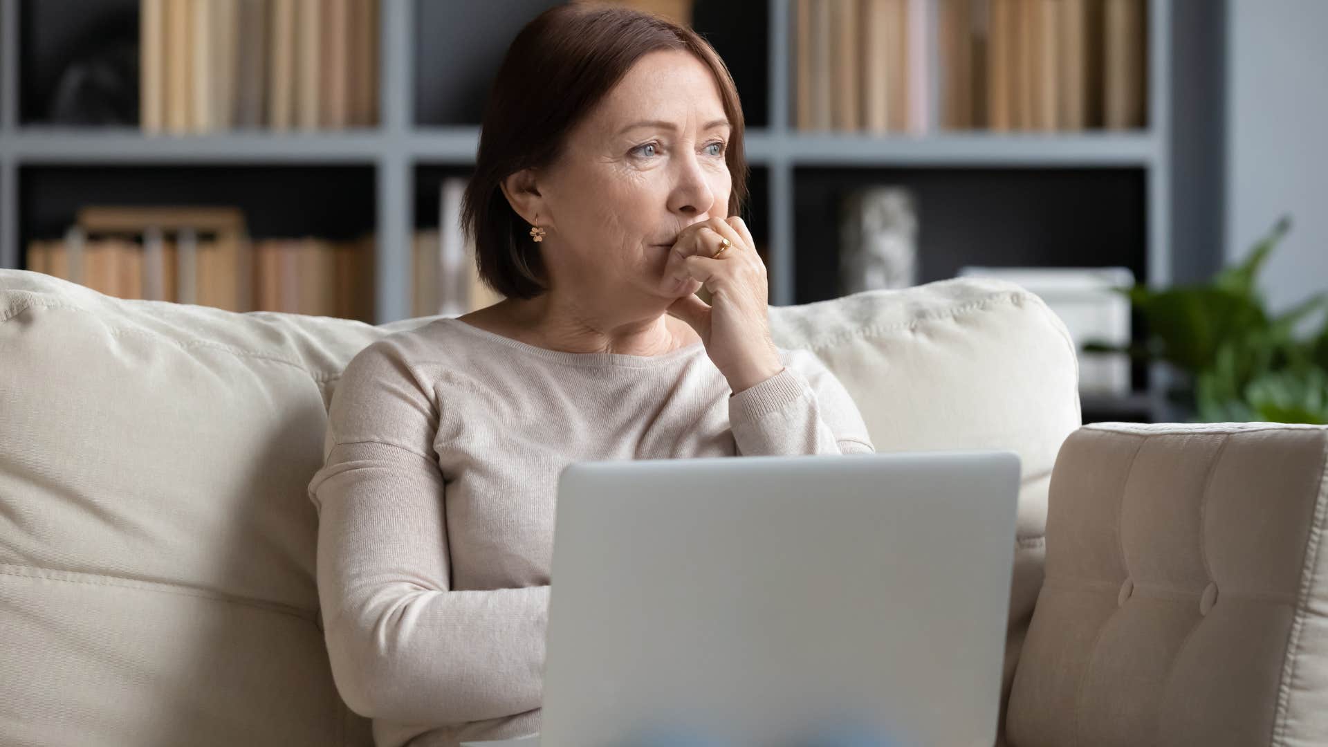 Woman turned away from the camera thinking about her kids who never check-in.