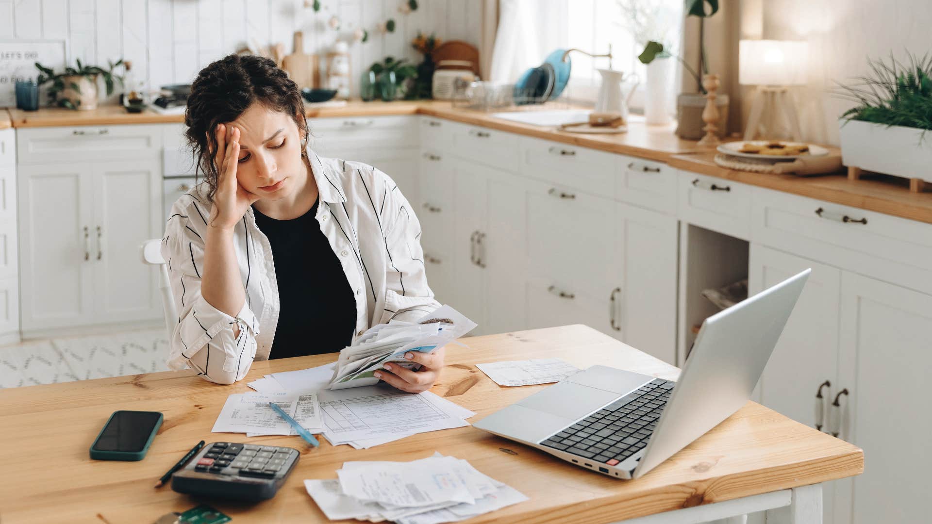 wife looking over bills at home