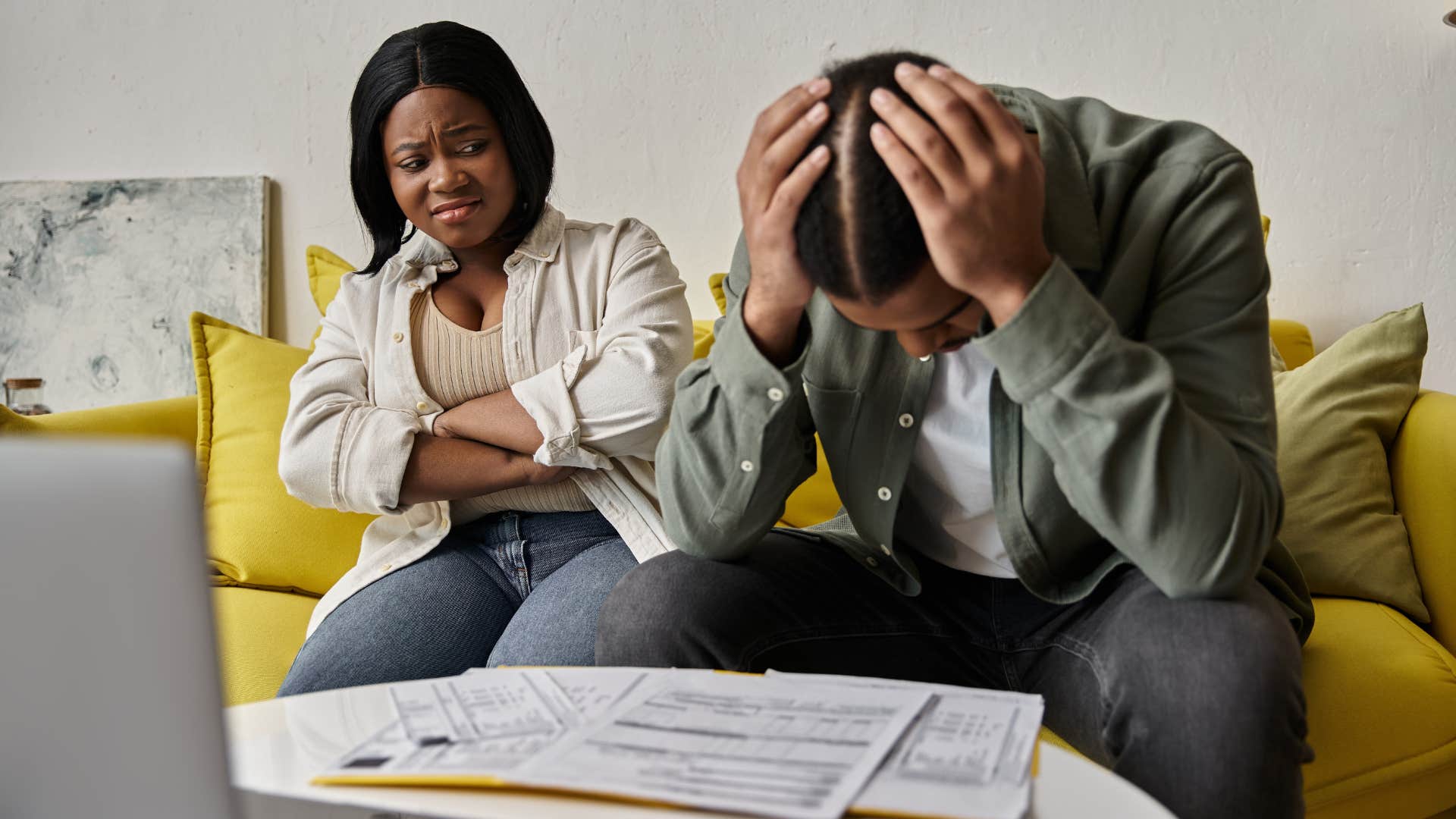 stressed husband and wife looking at overdue bill