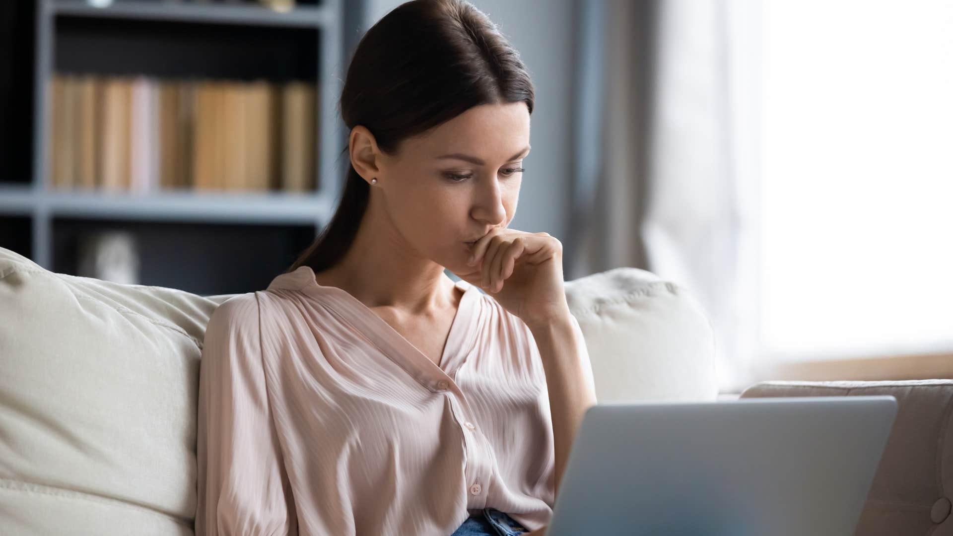 woman with a deep emotional mismatch reading article