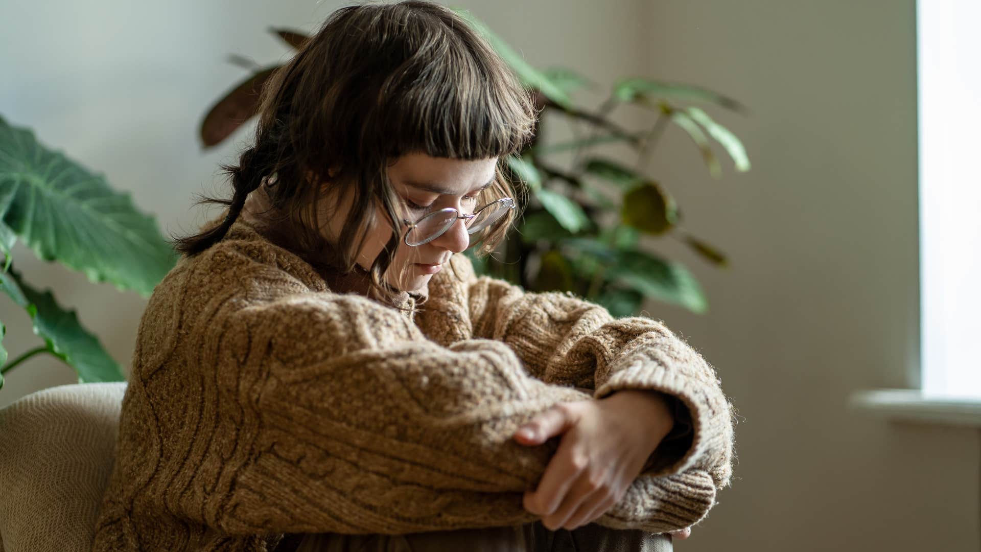 Upset Gen Z woman thinking about AI art pushing out human artists.