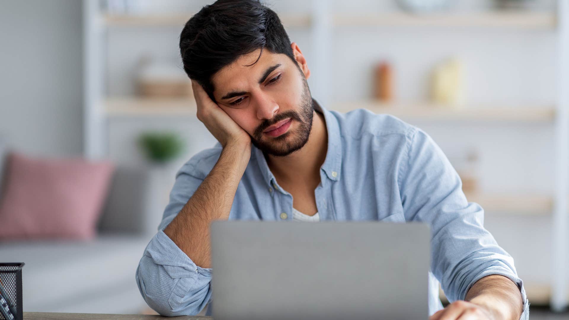 Upset Gen Z man thinking about how entry-level jobs are declining