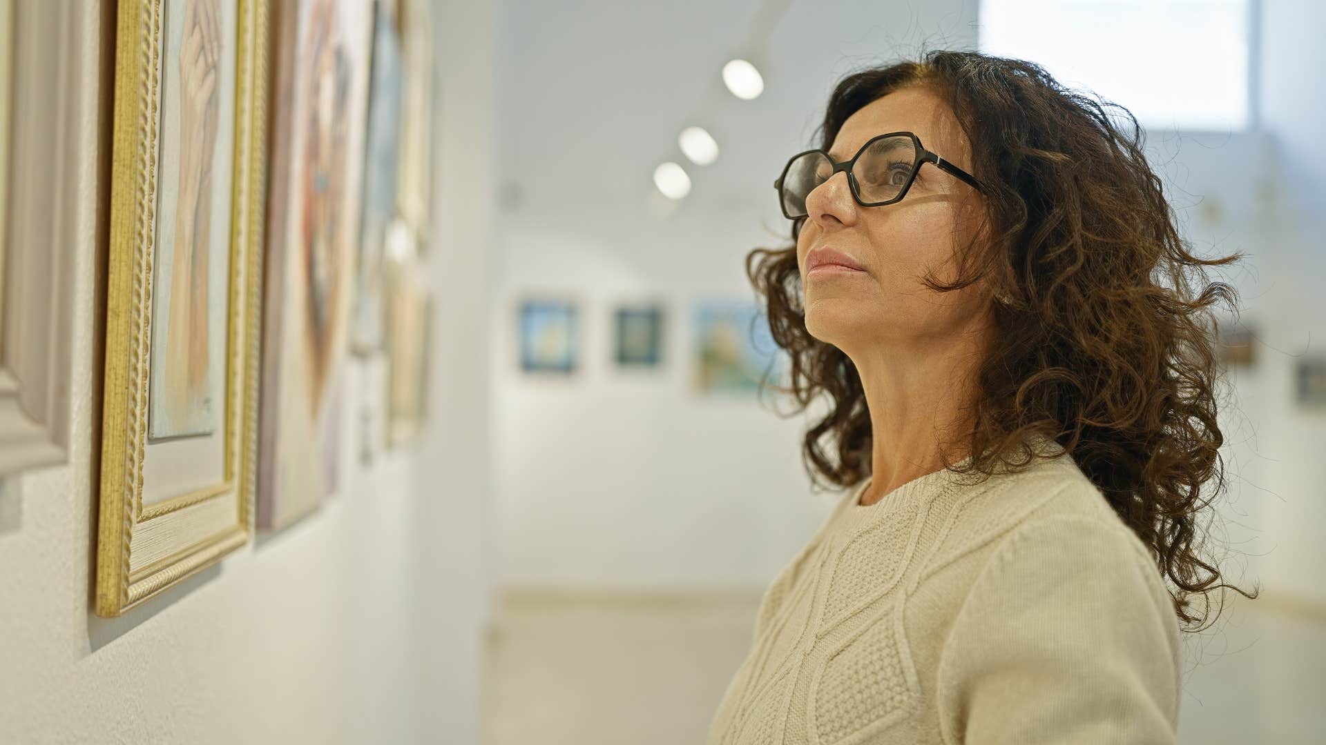 a woman feels in alignment with herself looking at 111 art she created