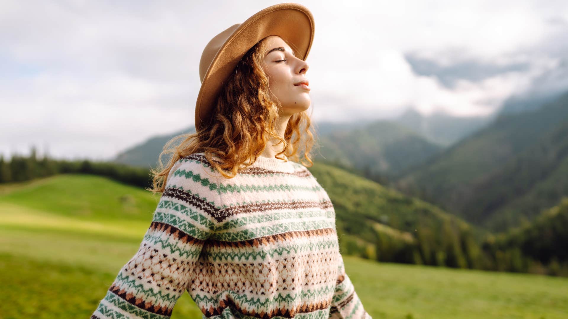 a woman explores the outdoors feeling protected by 333 the universe