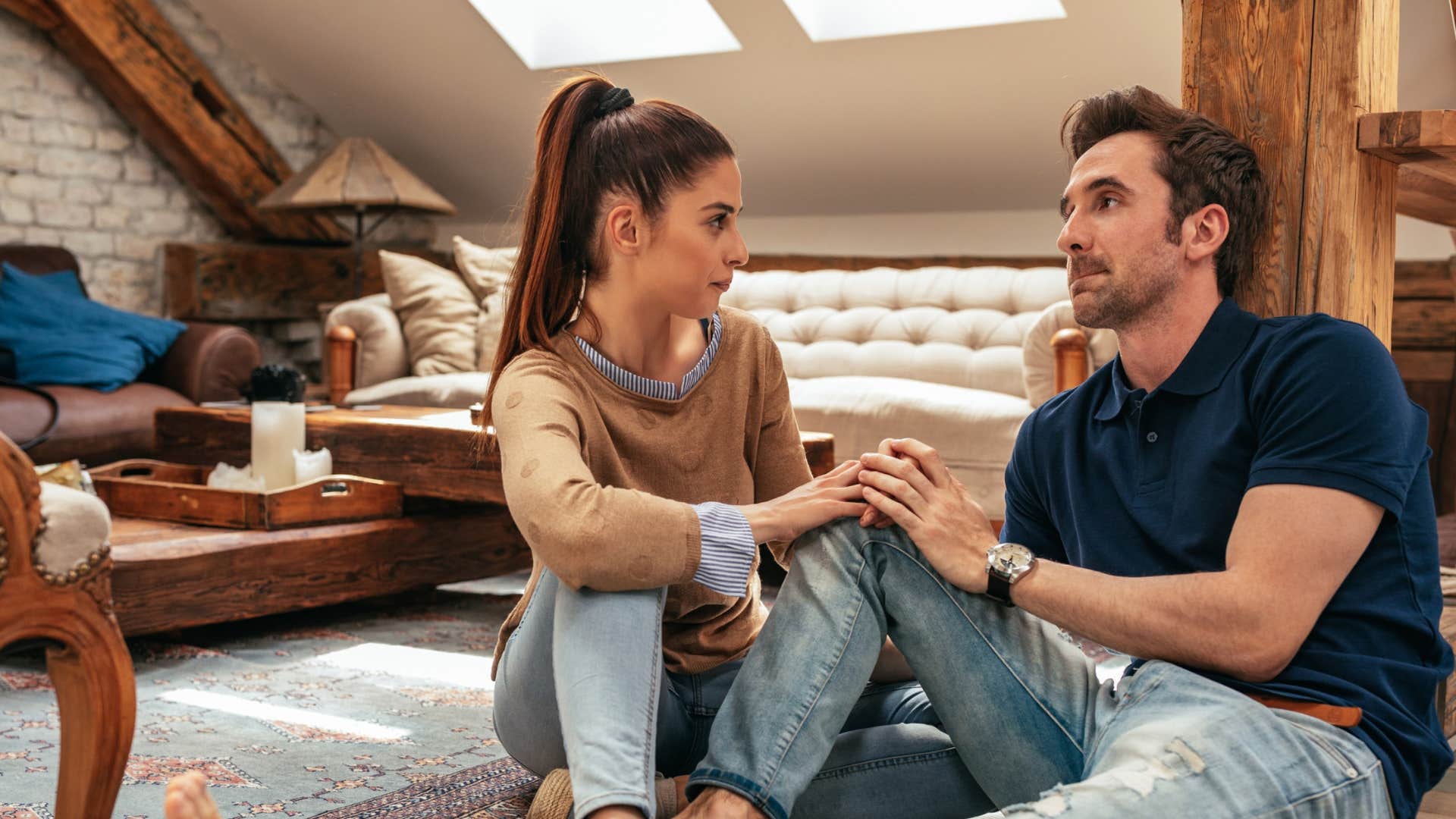 non-religious couple sitting on floor talking