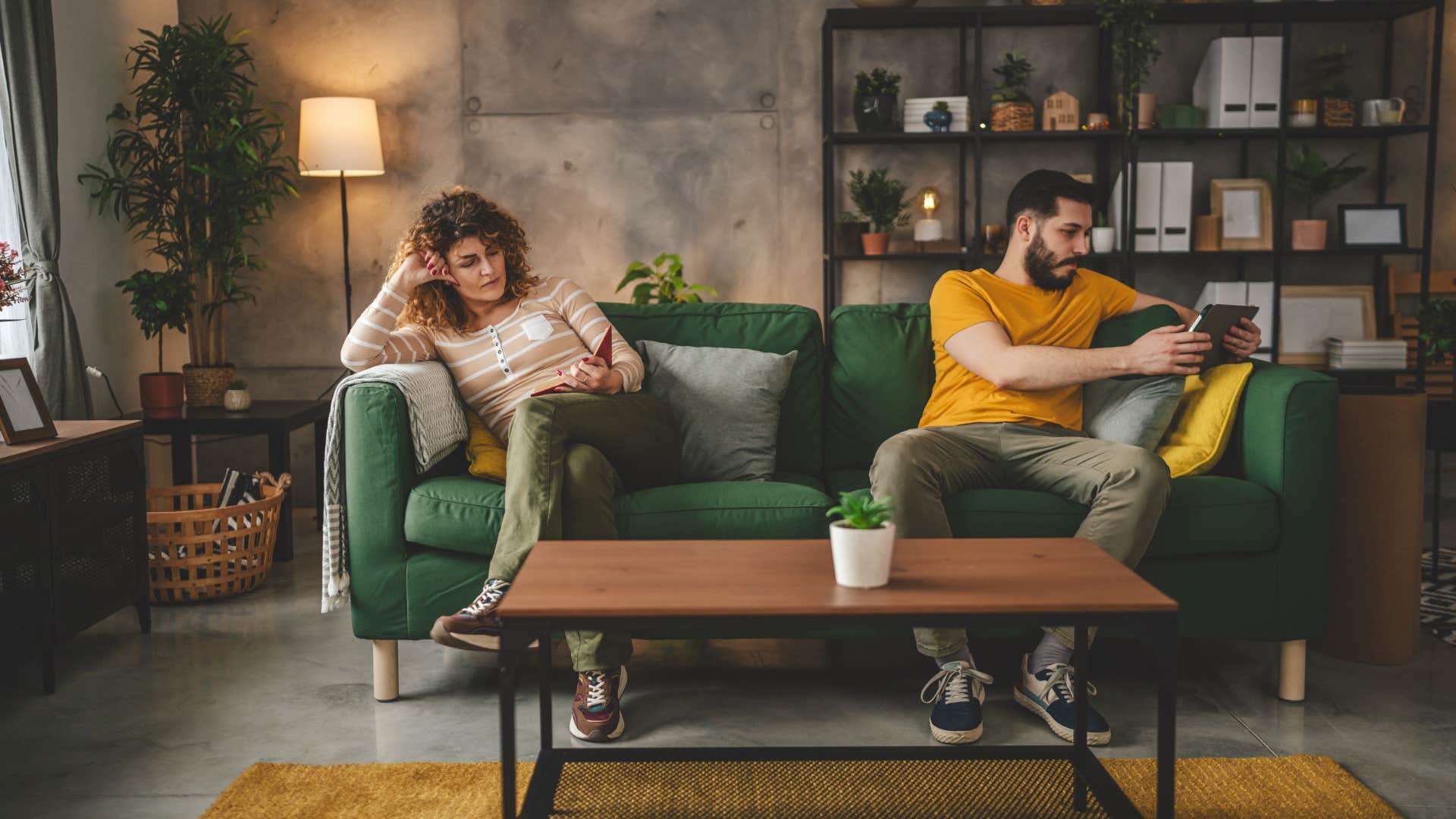 couple on couch giving each other personal space
