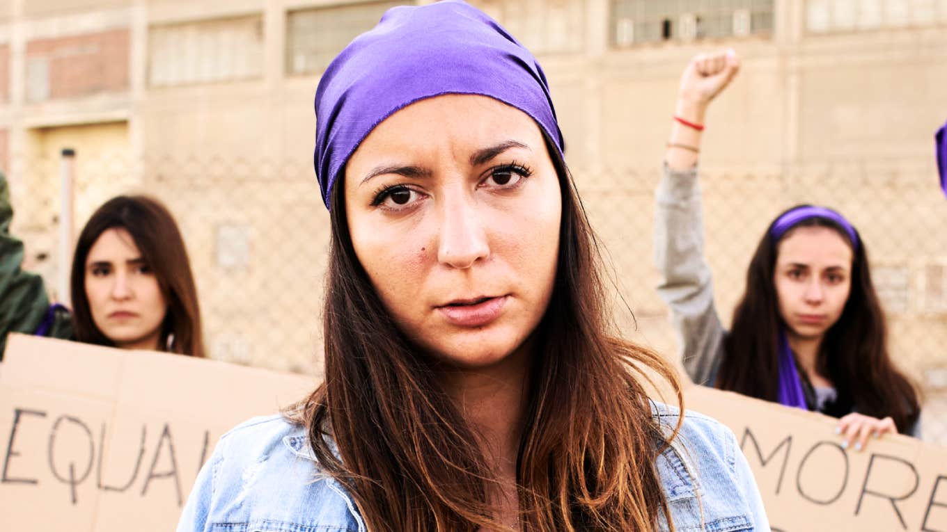 Should Feminists Care About Male Suffering? Feminist woman protesting.