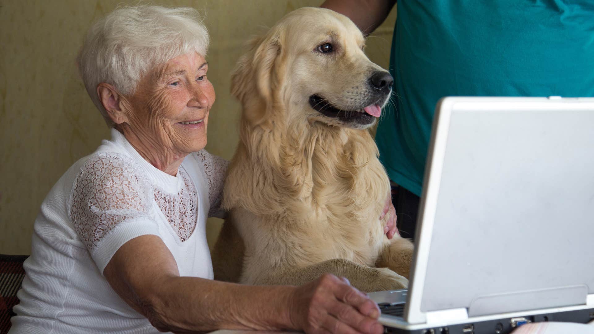 woman showing everyone her dog on laptop