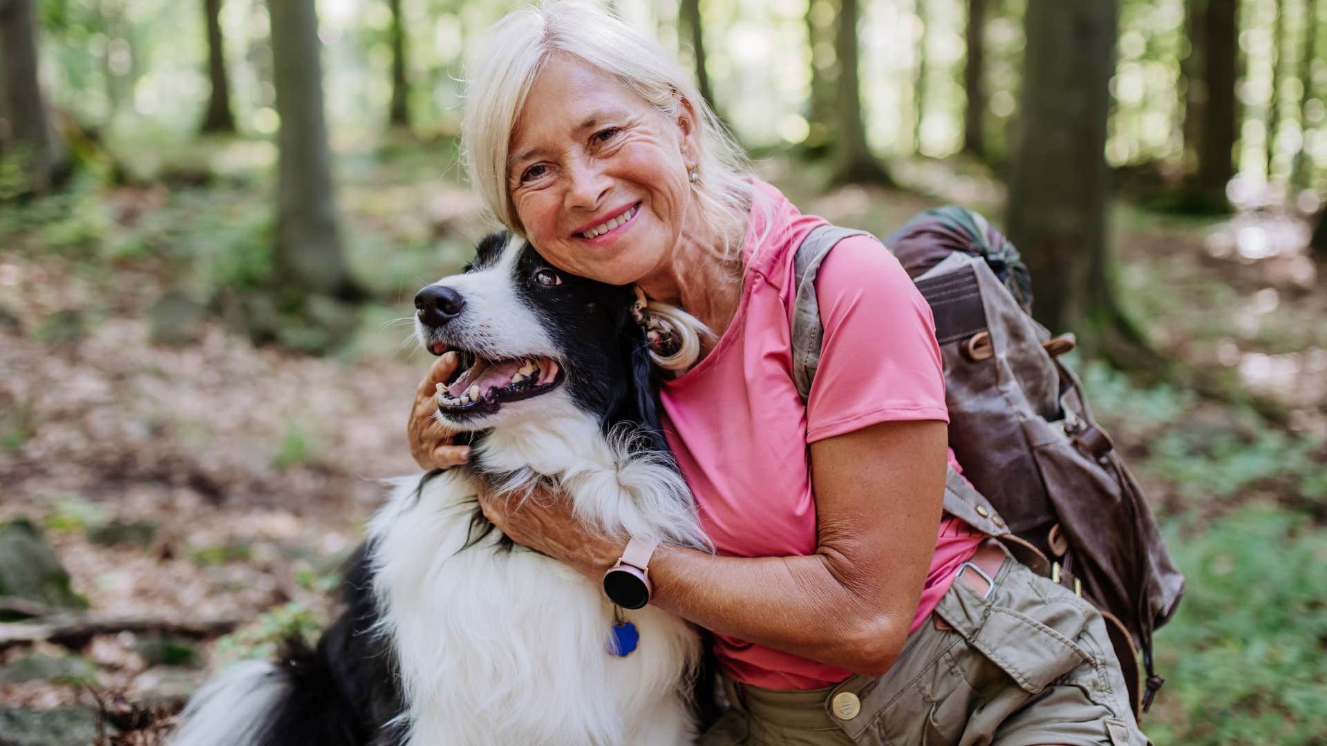 woman taking dog on a hike in nature