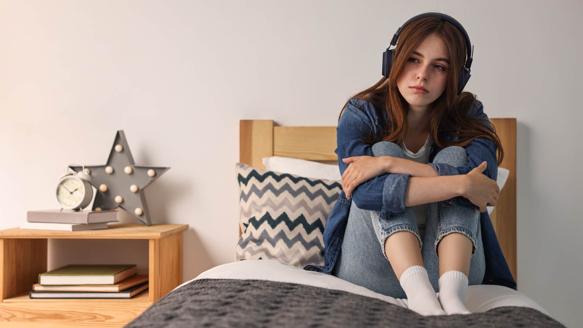 young woman in her room alone to avoid conflict