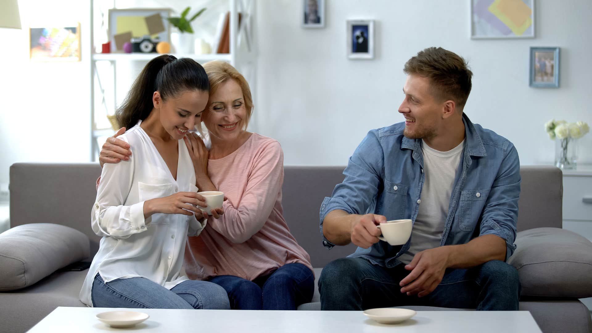 a man proudly shows off his girlfriend to his mother