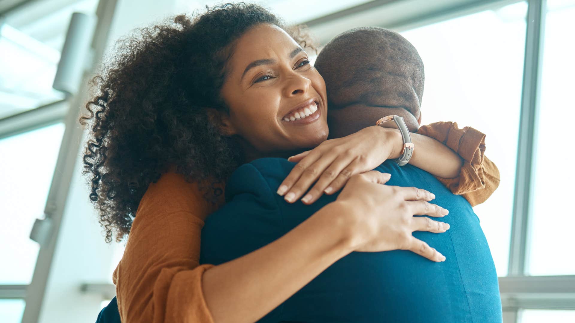 Woman smiling and reconnecting with old friends.