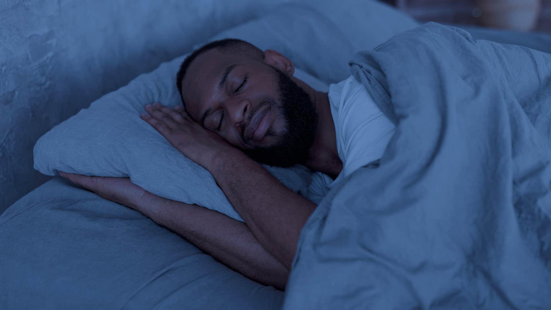 Man having vivid dreams laying in bed at night.