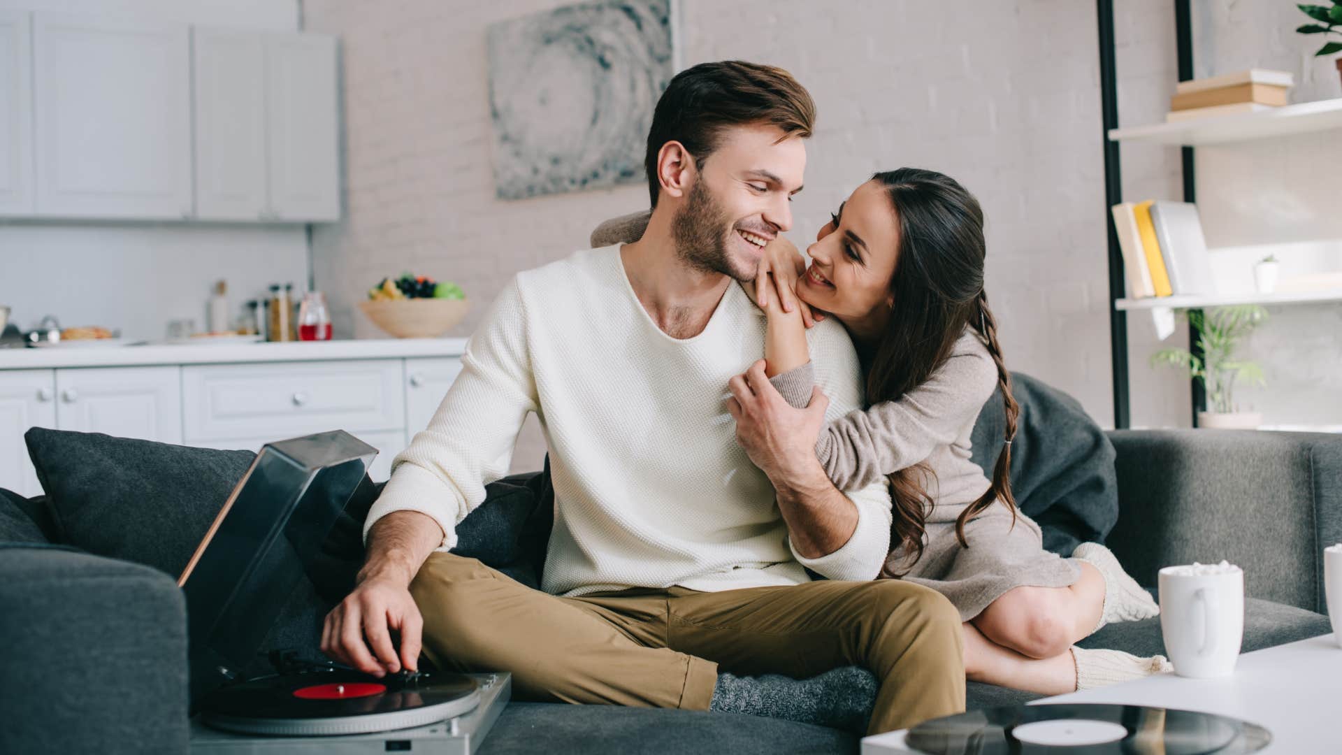 couple feeling attracted to each other snuggling on the couch