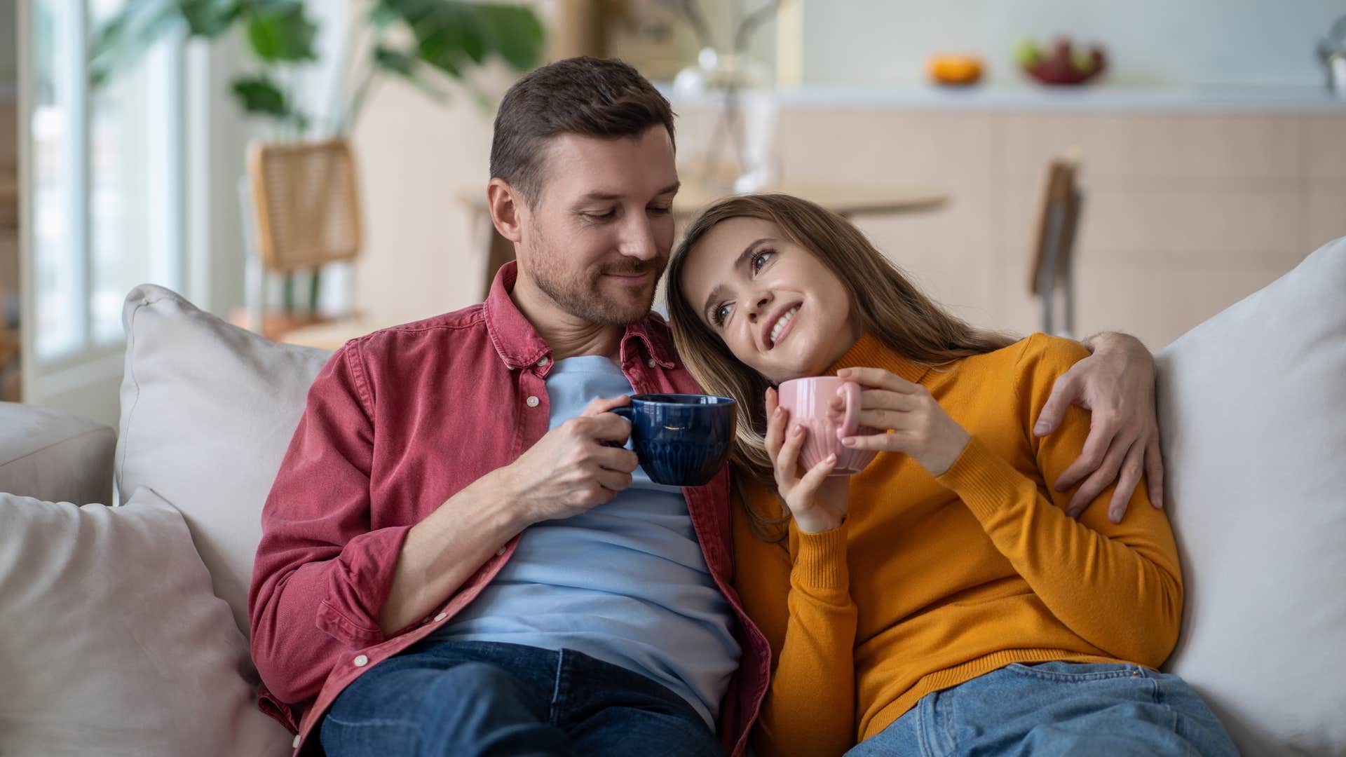 happy couple talking openly on the couch