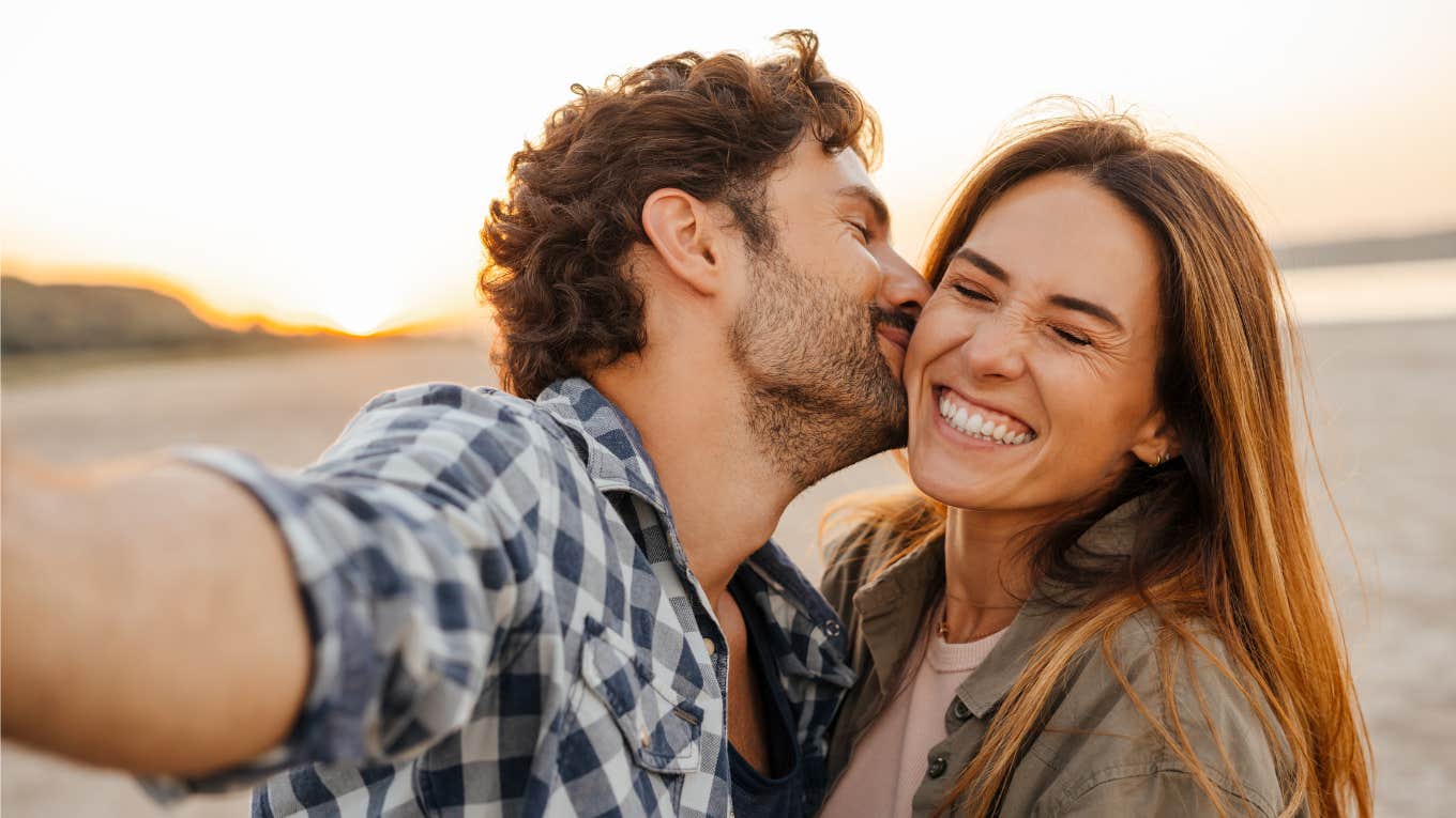 Signs The Two Of You Are Simply Meant To Be Together couple happily kissing and smiling meant to be together