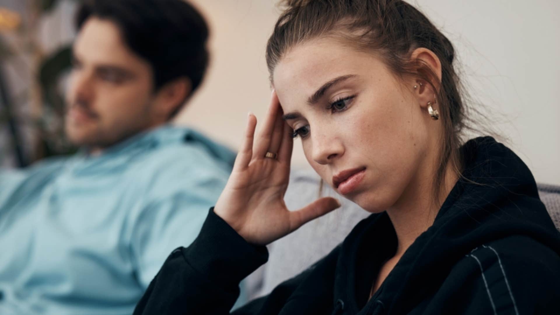 sad woman suppressing her emotions to avoid conflict with her boyfriend 