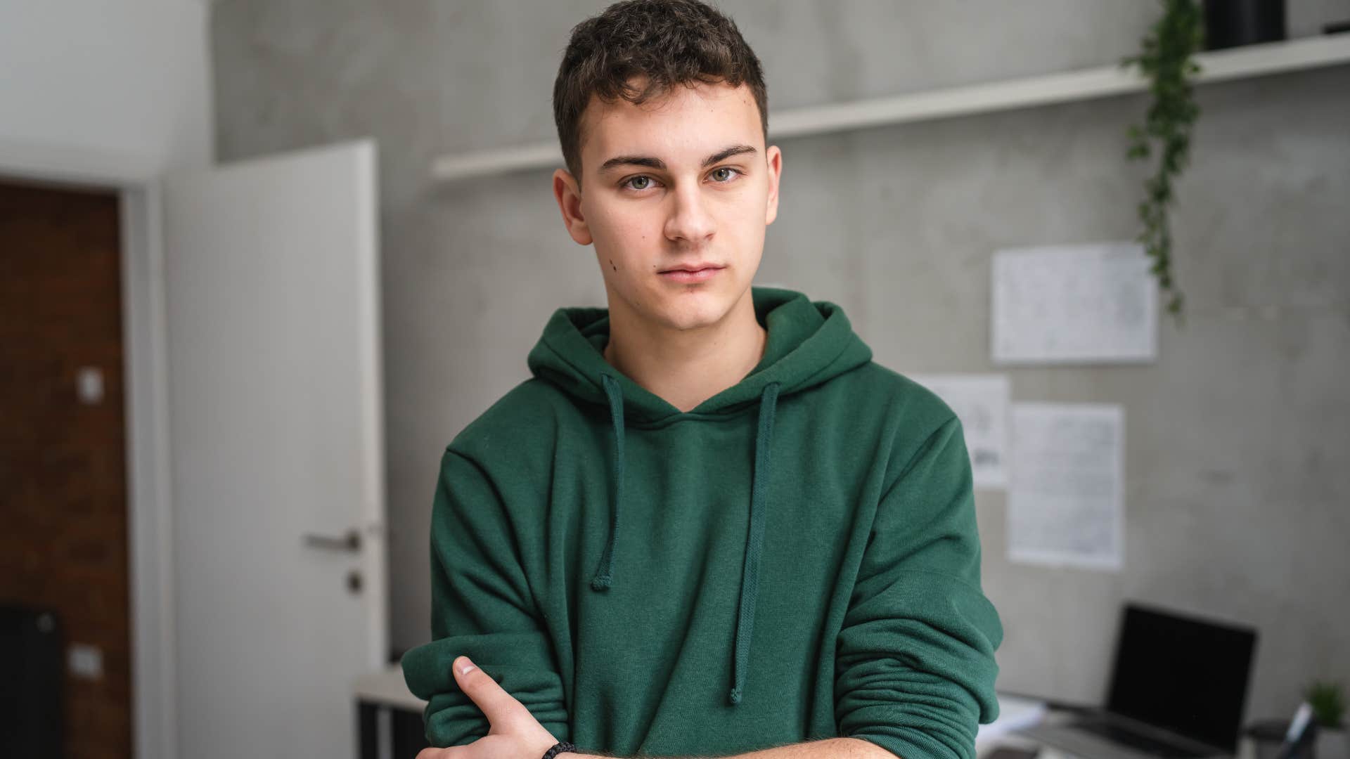 Teenage boy who grew up too fast looking seriously at the camera.