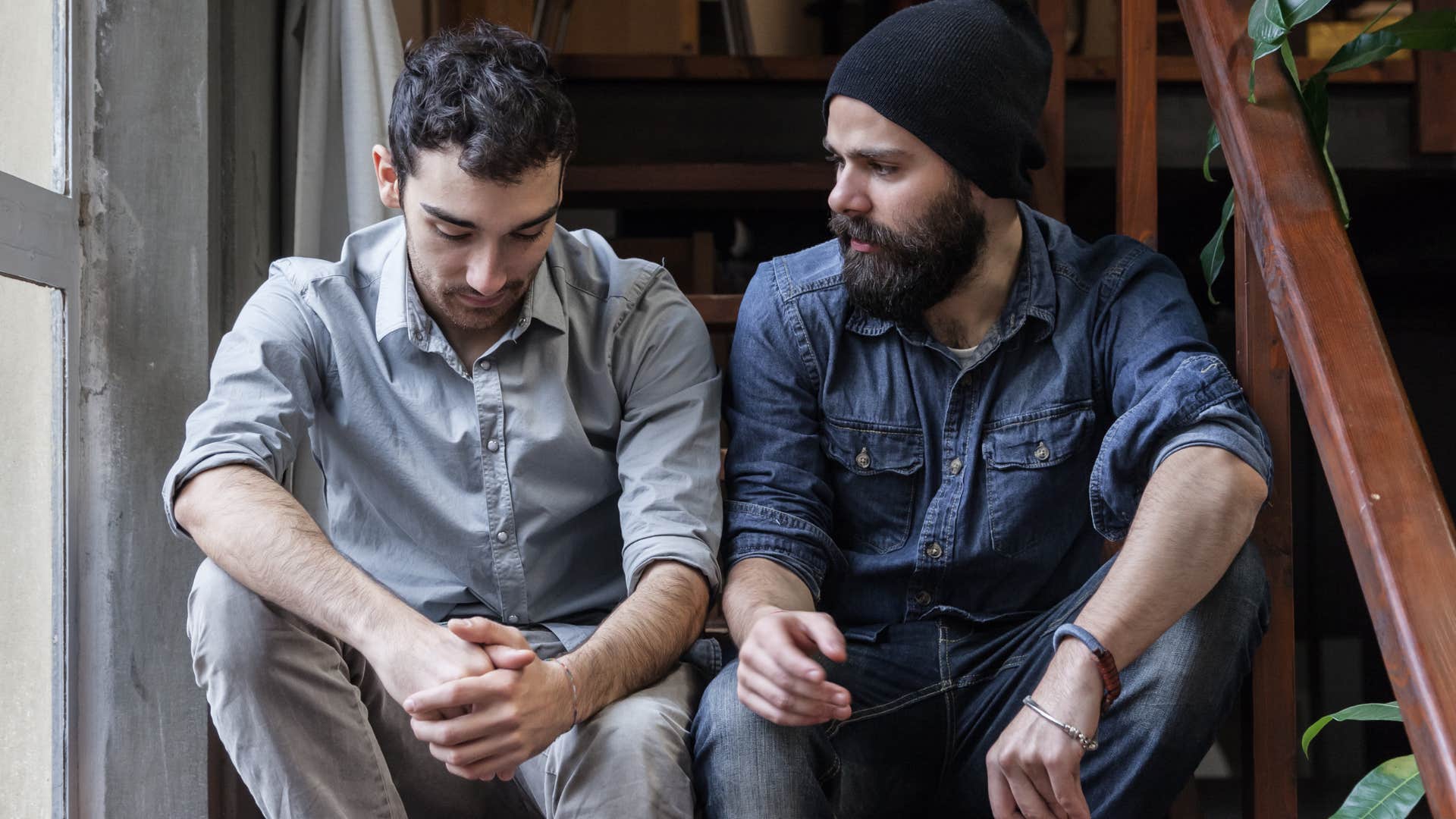 man sitting next to his friend who's hyper-aware of energy