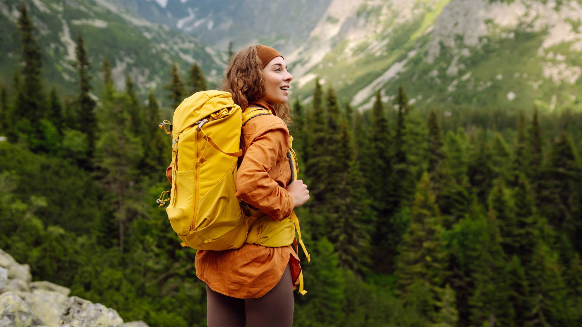 woman part of xennial generation backpacking