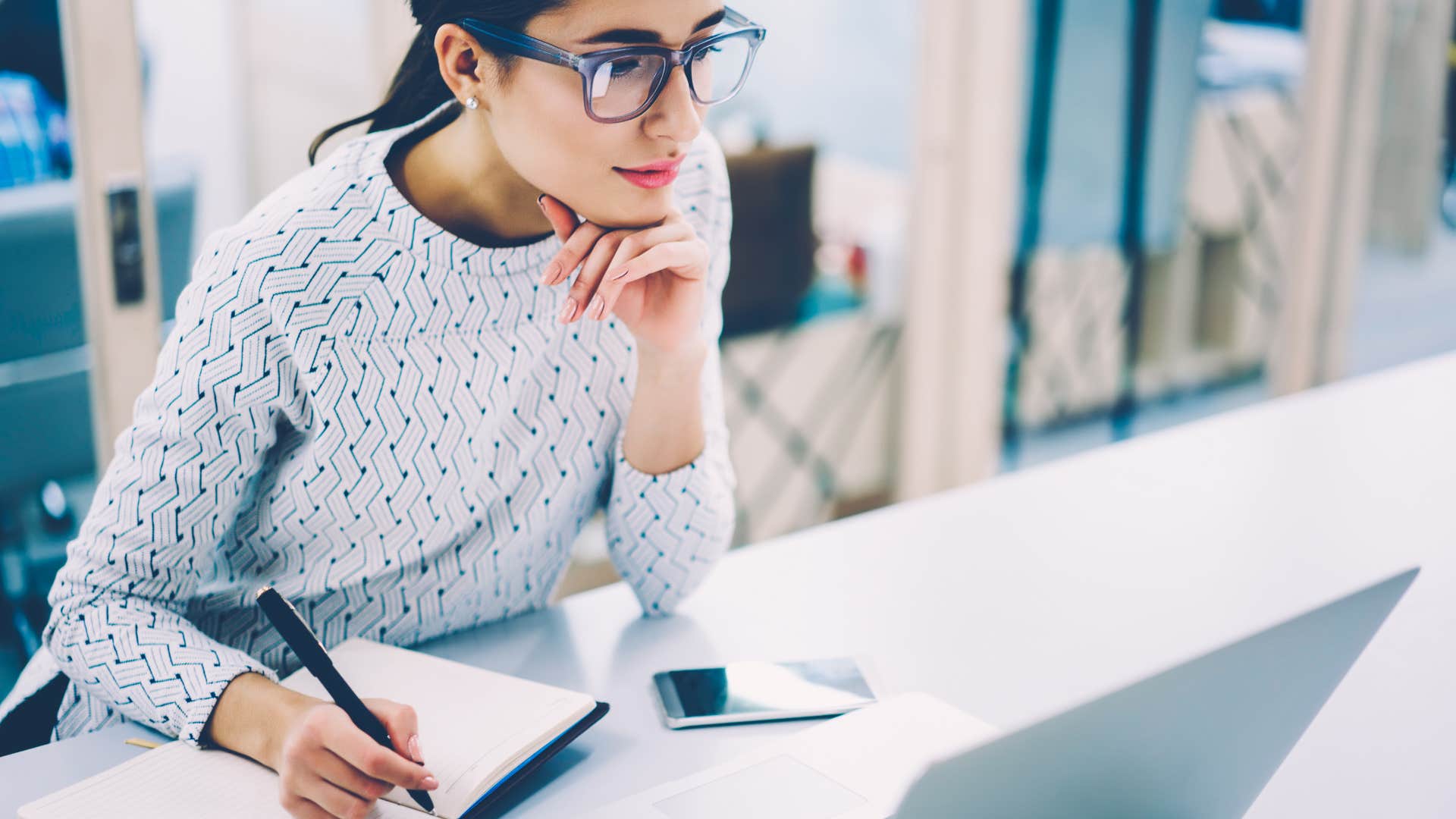 woman apart of xennial generation using pen and paper