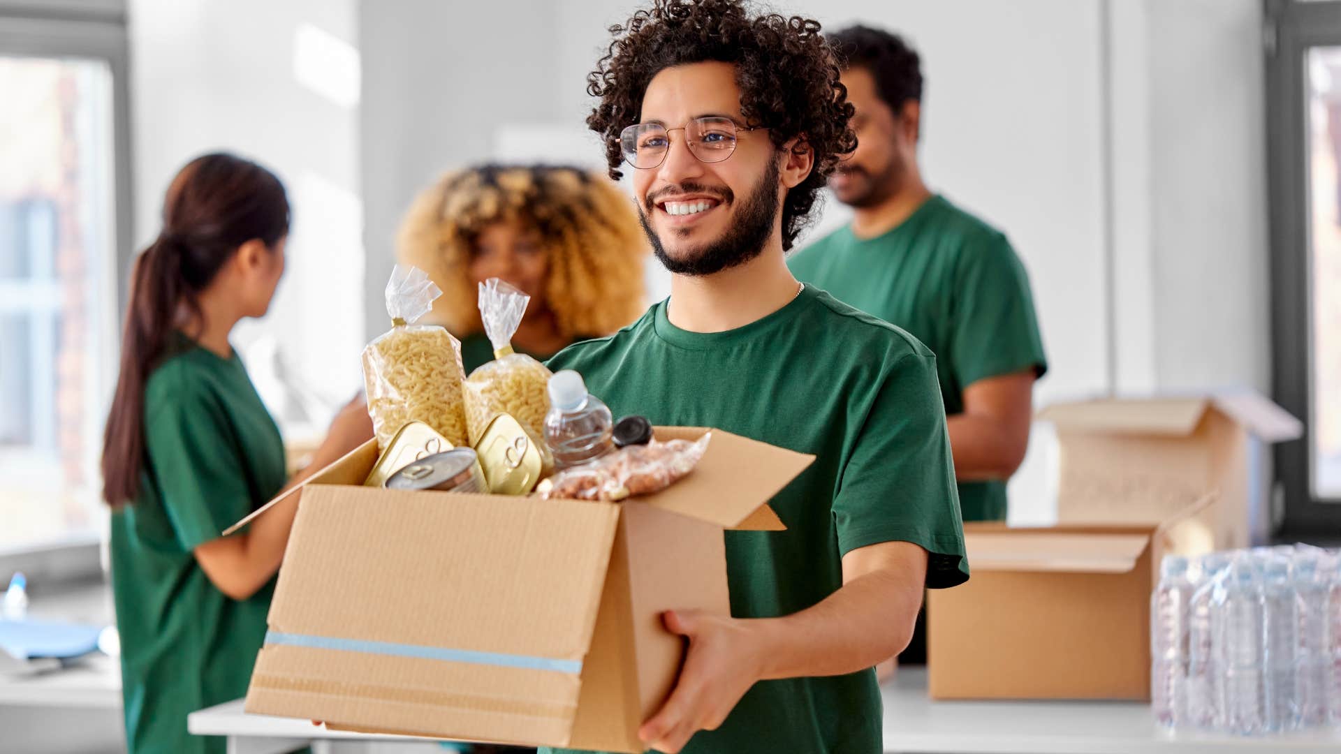 a volunteer moves donations to give them to people in need