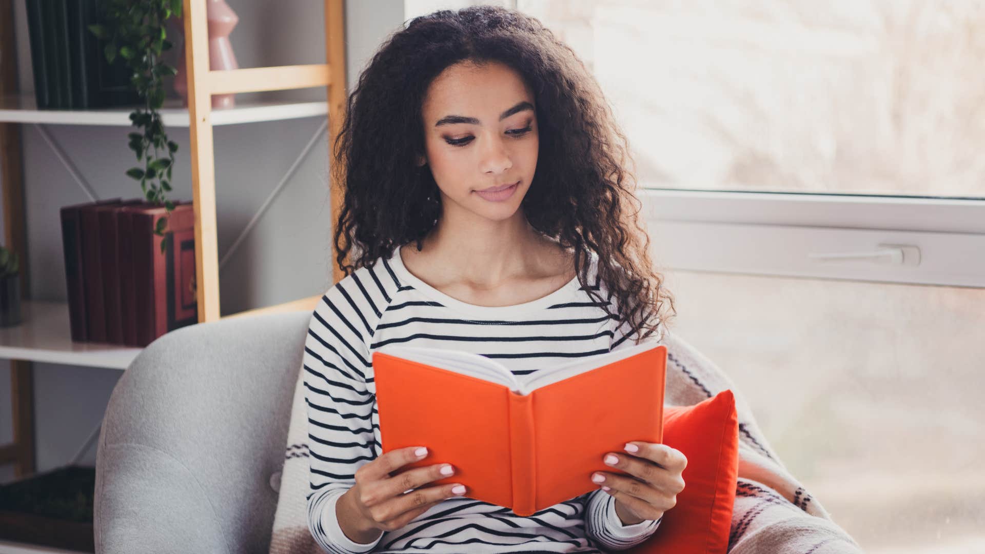 a young woman reads a book instead of scrolling through social media