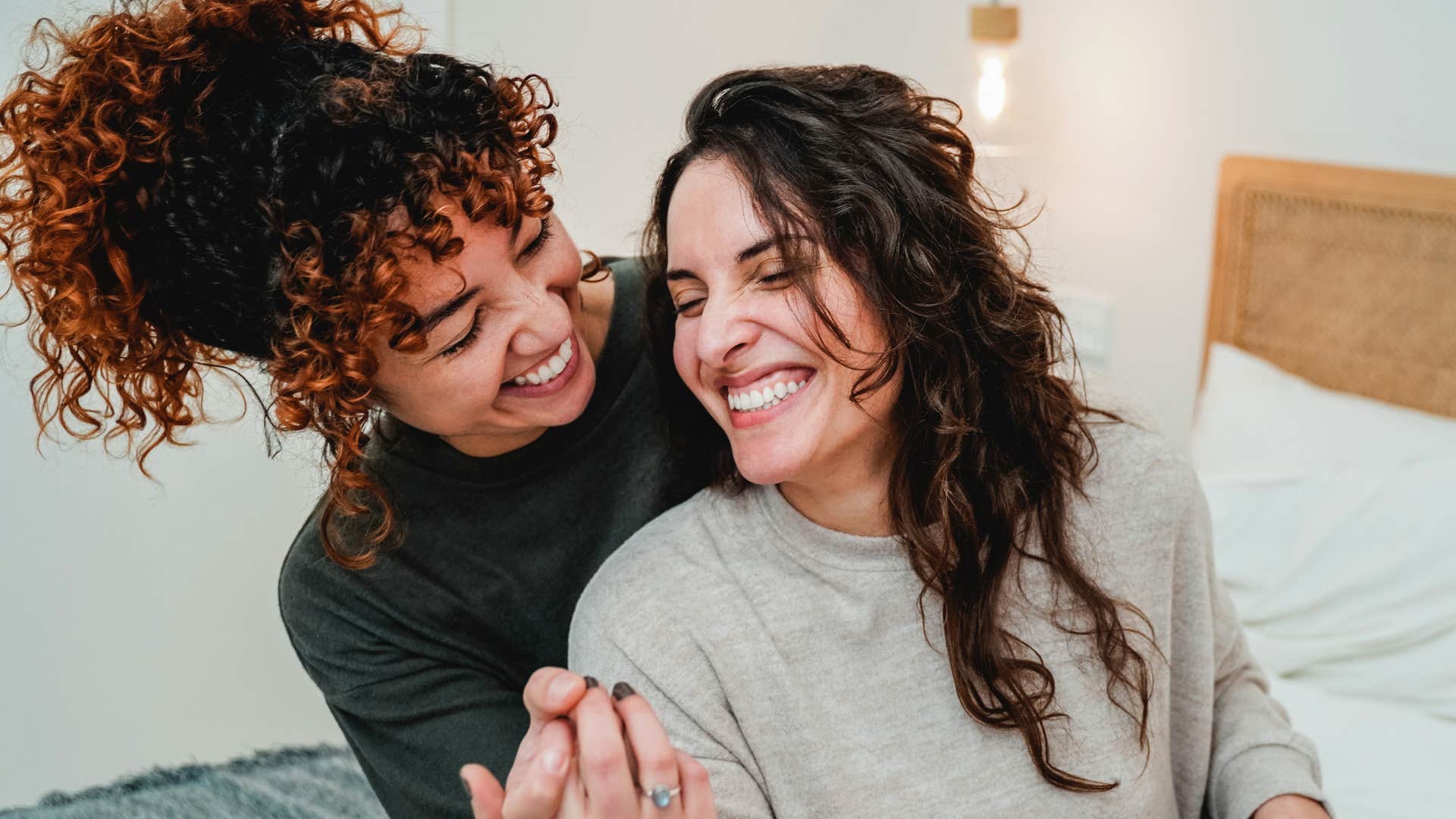 Woman who helps her partner reach her goals smiling and hugging.