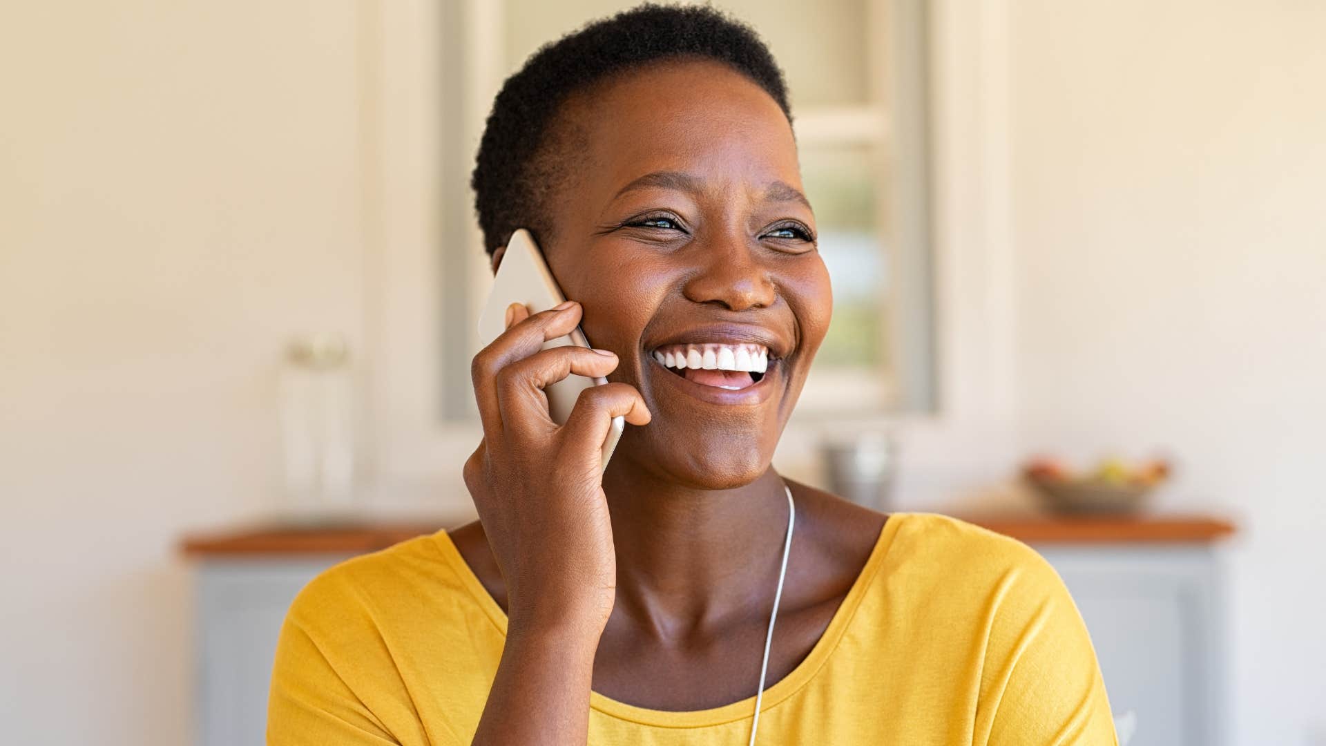 Woman who speaks highly of her partner talking on the phone.