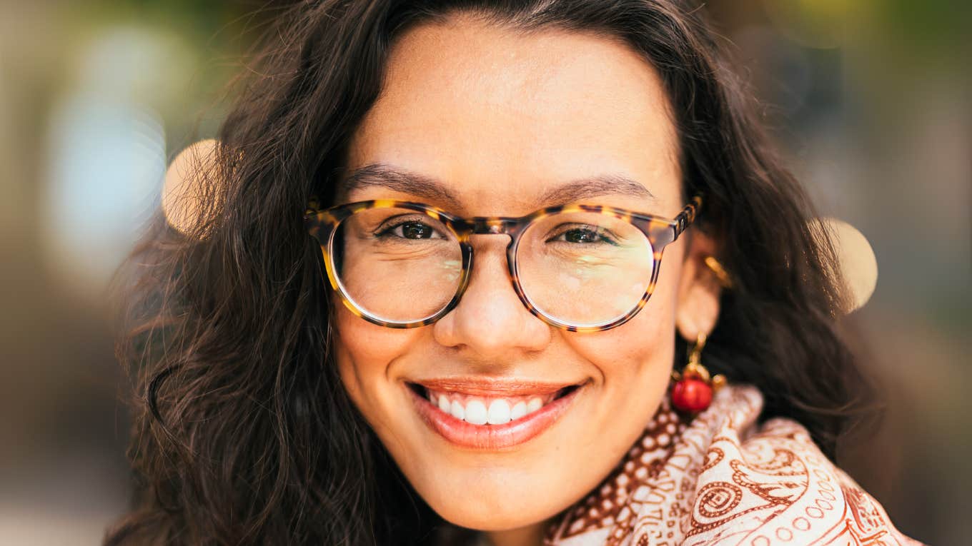 Small Daily Decisions That Set Truly Happy People Apart, According To Psychology Truly happy woman, making small daily decisions to set her apart.