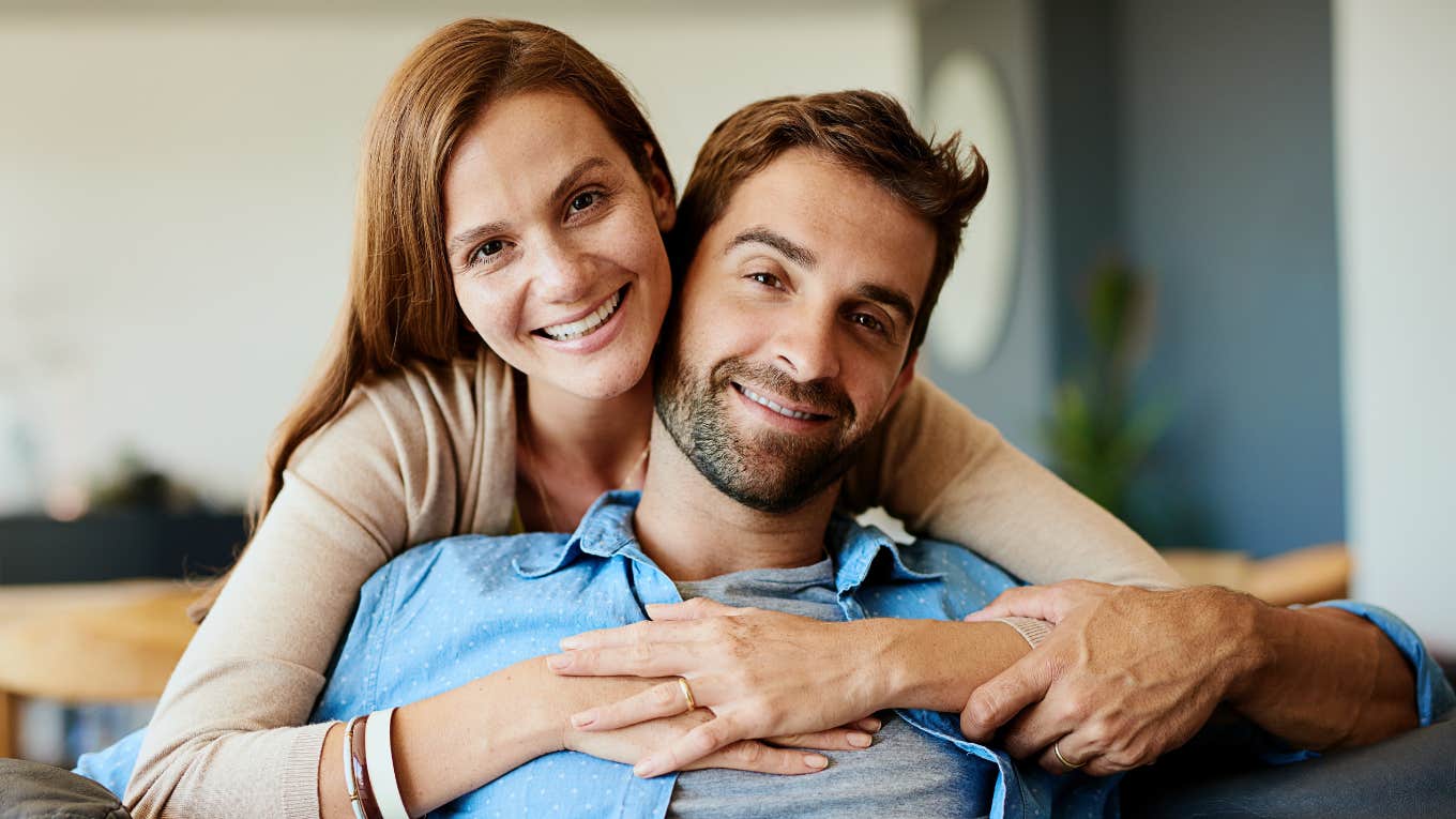 Small Moments That Reveal How Deeply A Woman Loves You woman lovingly embracing husband from behind