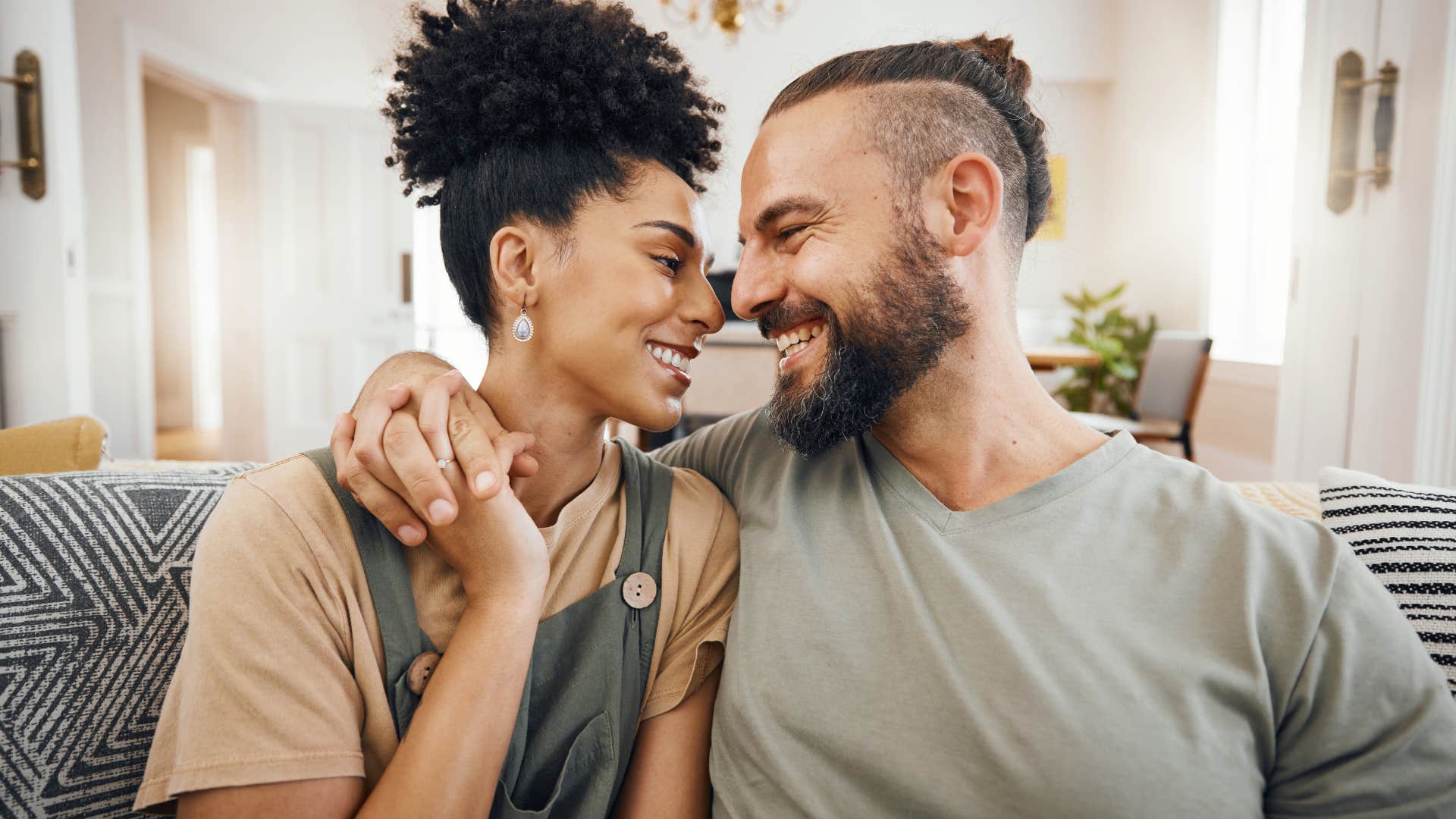 man encouraging woman to pursue her goals smiling holding hands