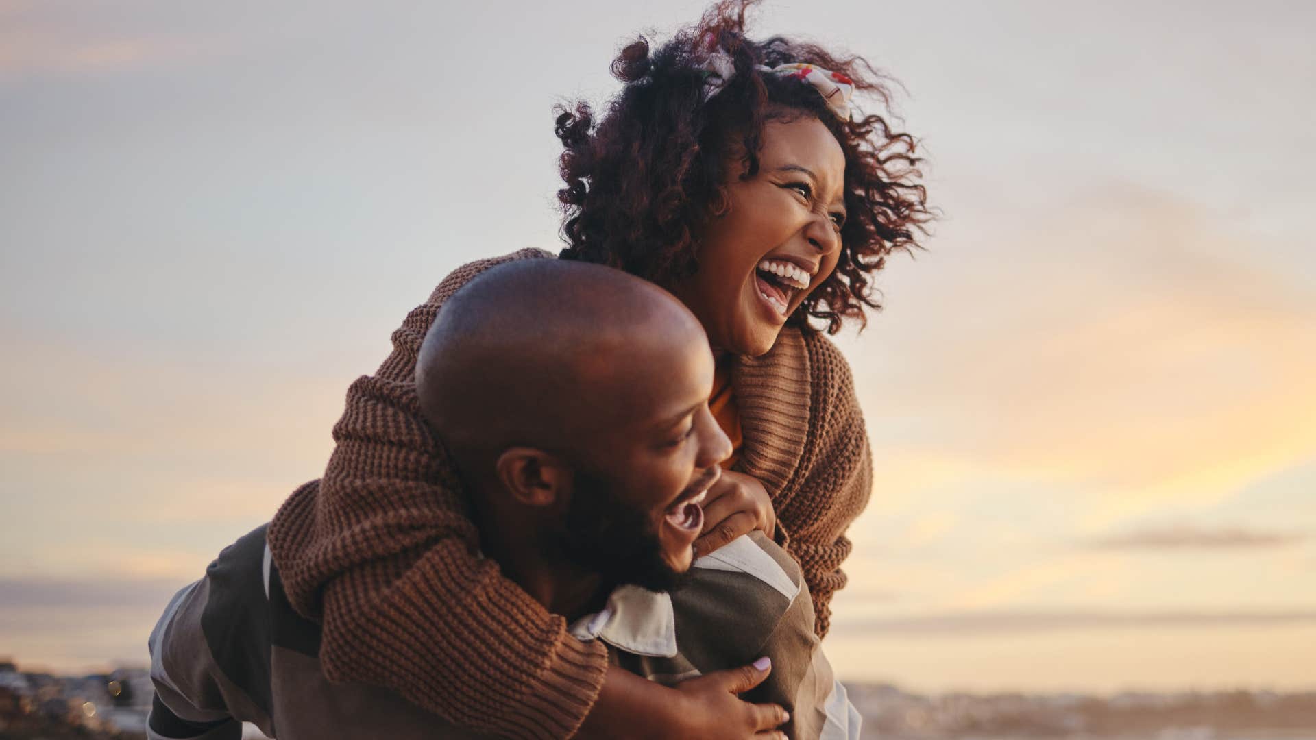 happy couple piggyback man prioritizes his wife's comfort