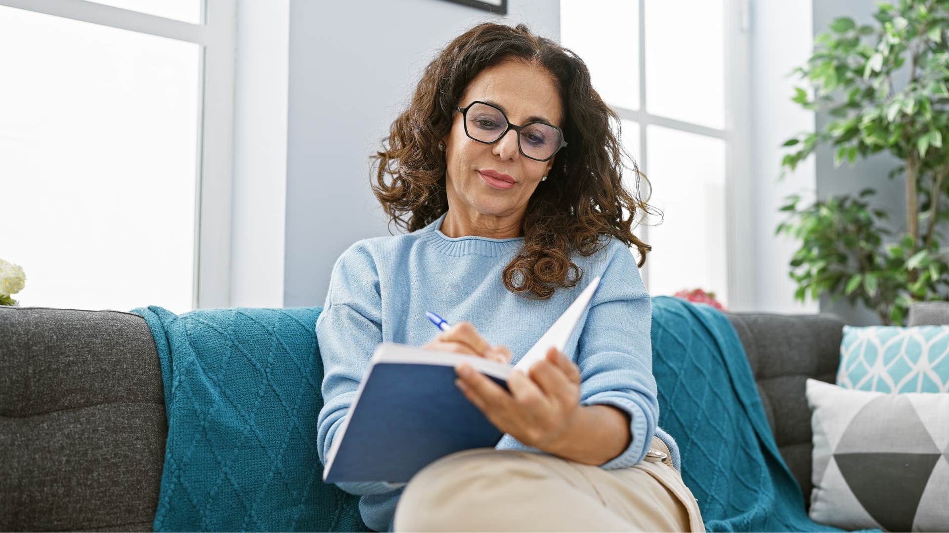 woman writing in her gratitude journal