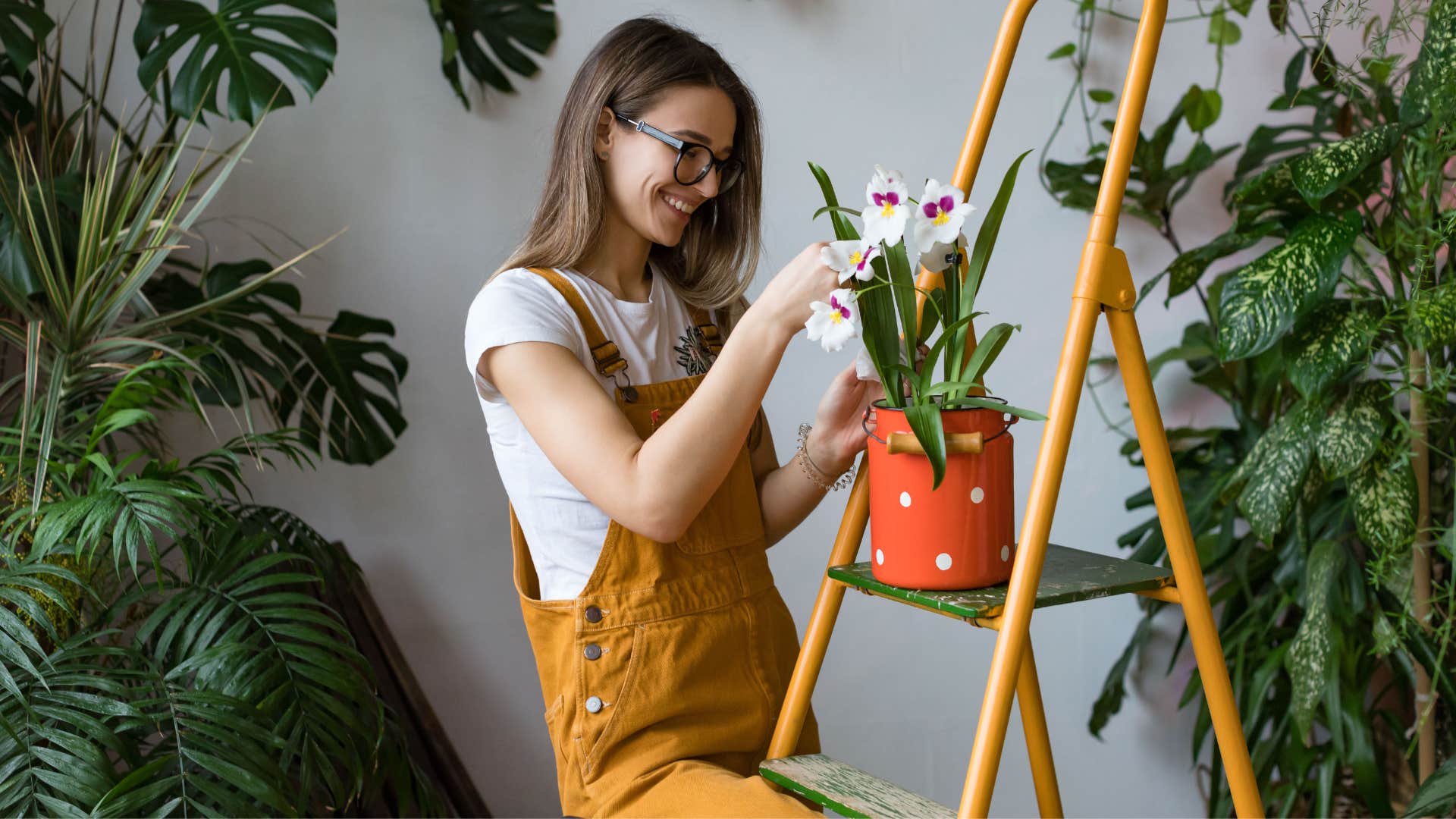 smiling woman putting flowers all around her