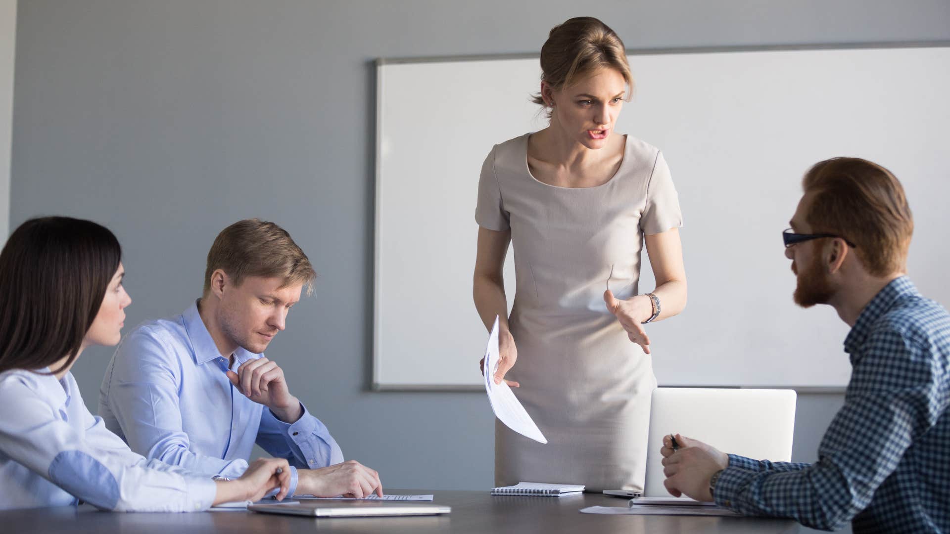 a woman leaves a board room meeting after being disrespected by a colleague