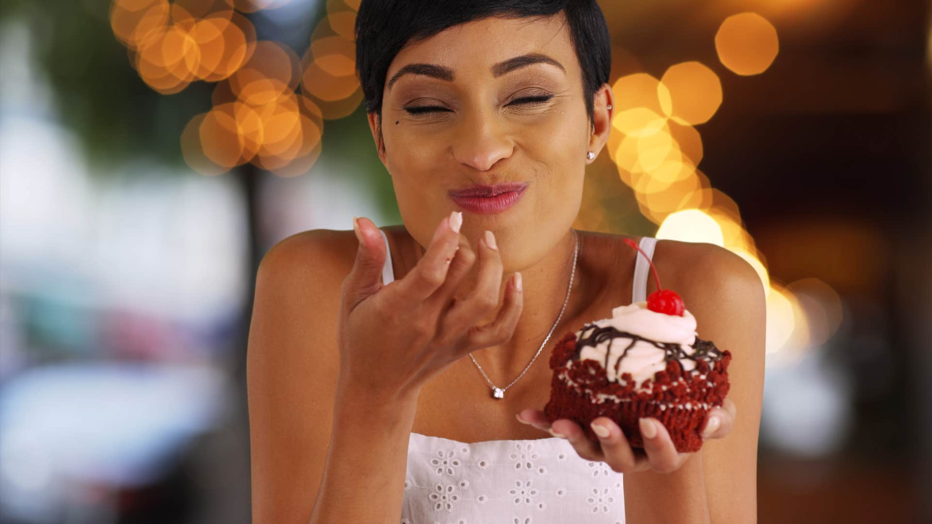 woman craving a cupcake and eating it