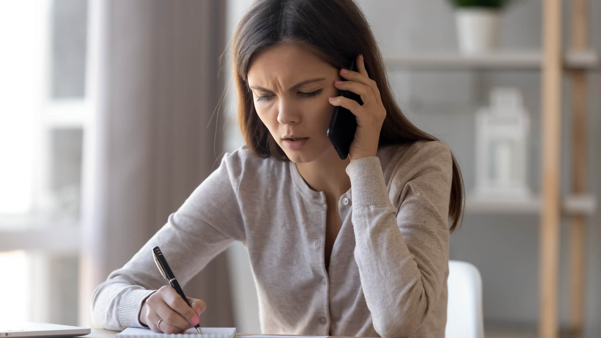 woman in marriage falling apart writing everything she spends money on