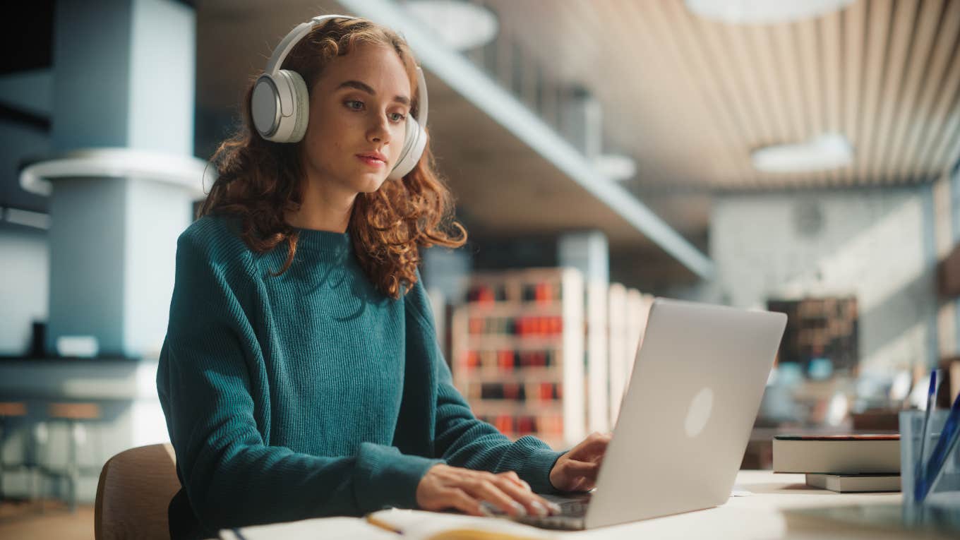 Student Demands Refund After Professor Uses ChatGPT concentrated student working on laptop