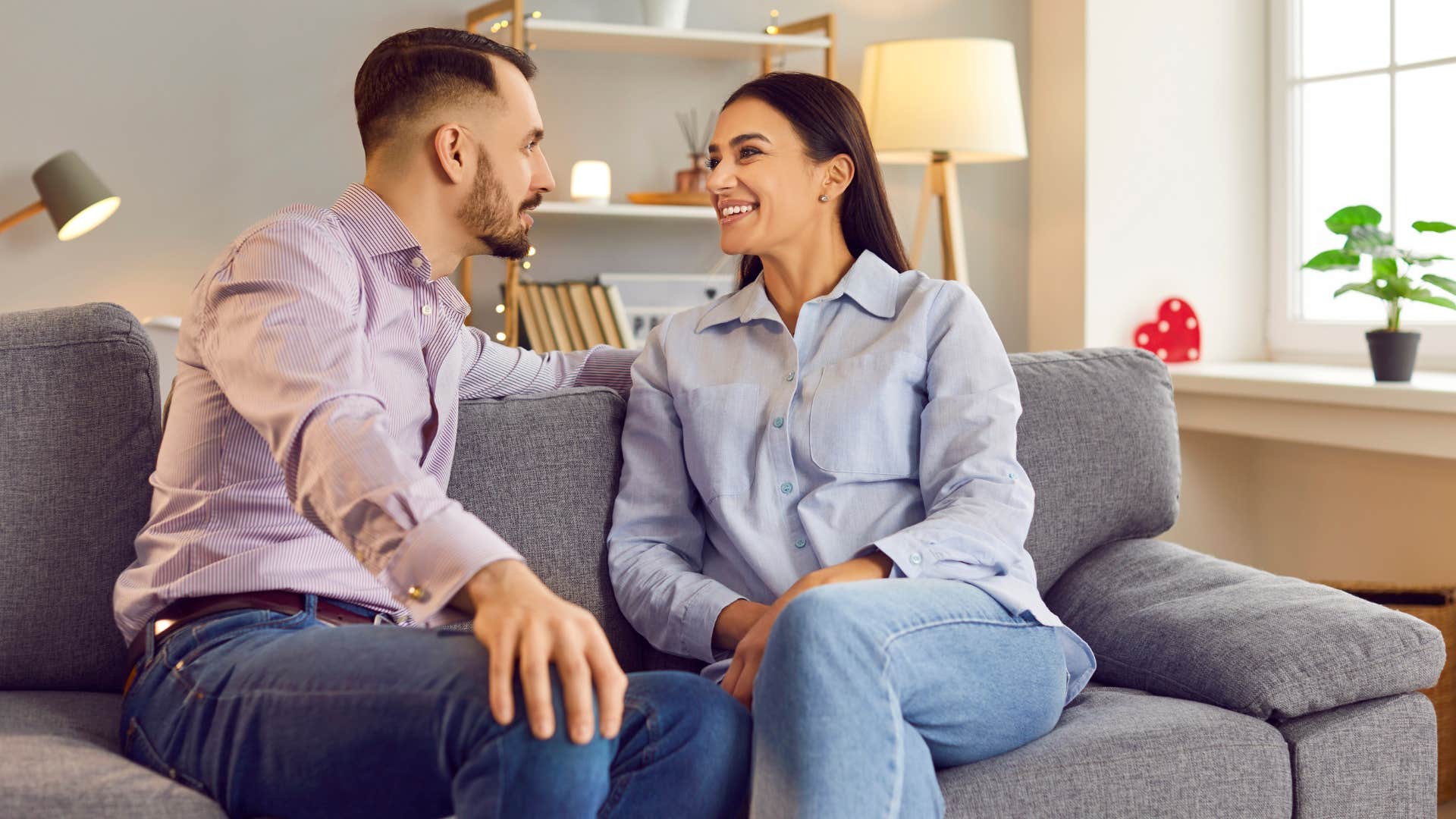 couple pointing their feet toward each other on couch