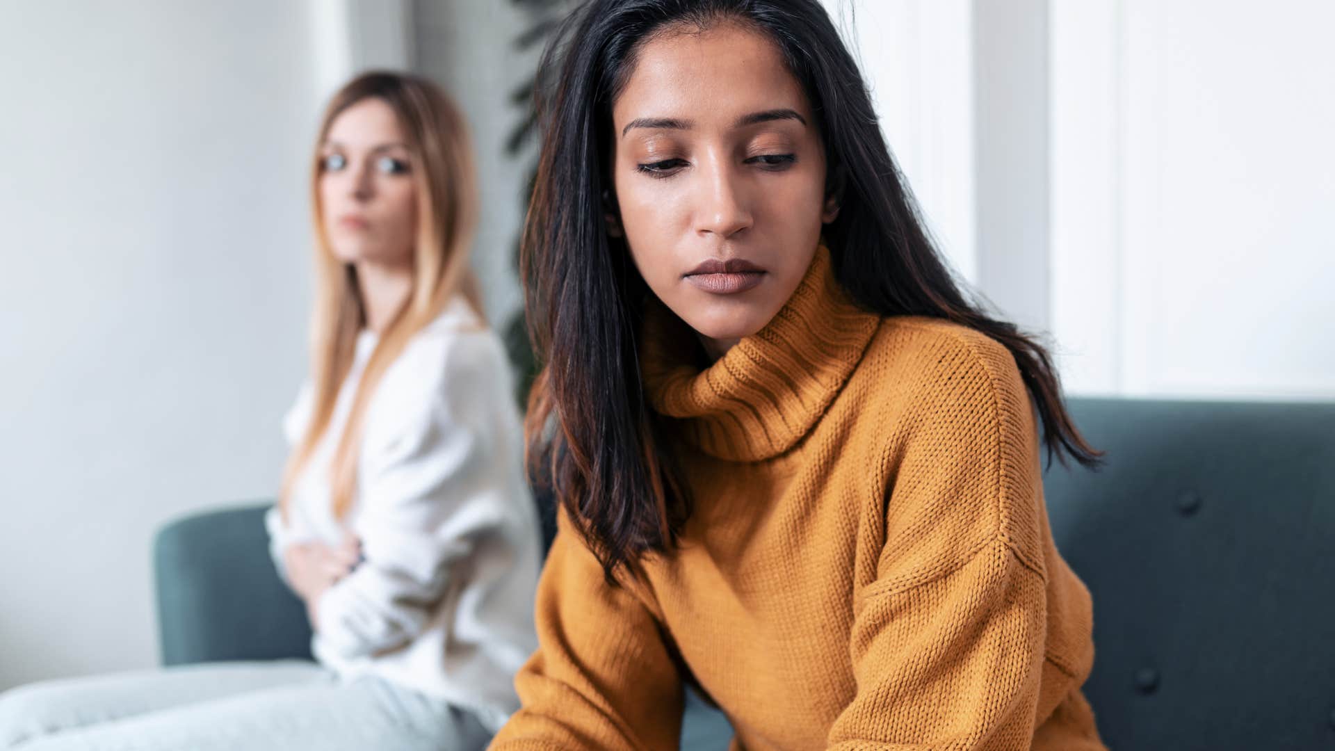 woman giving subtle clues of trying to avoid other woman