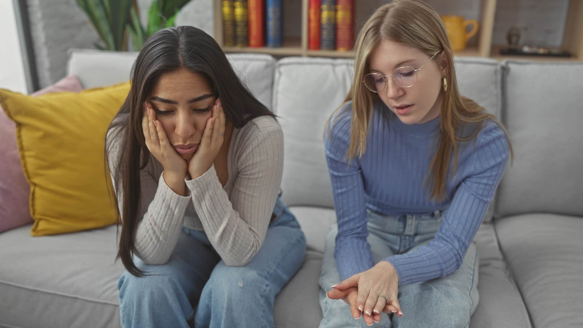 Woman avoiding confrontation next to her friend.