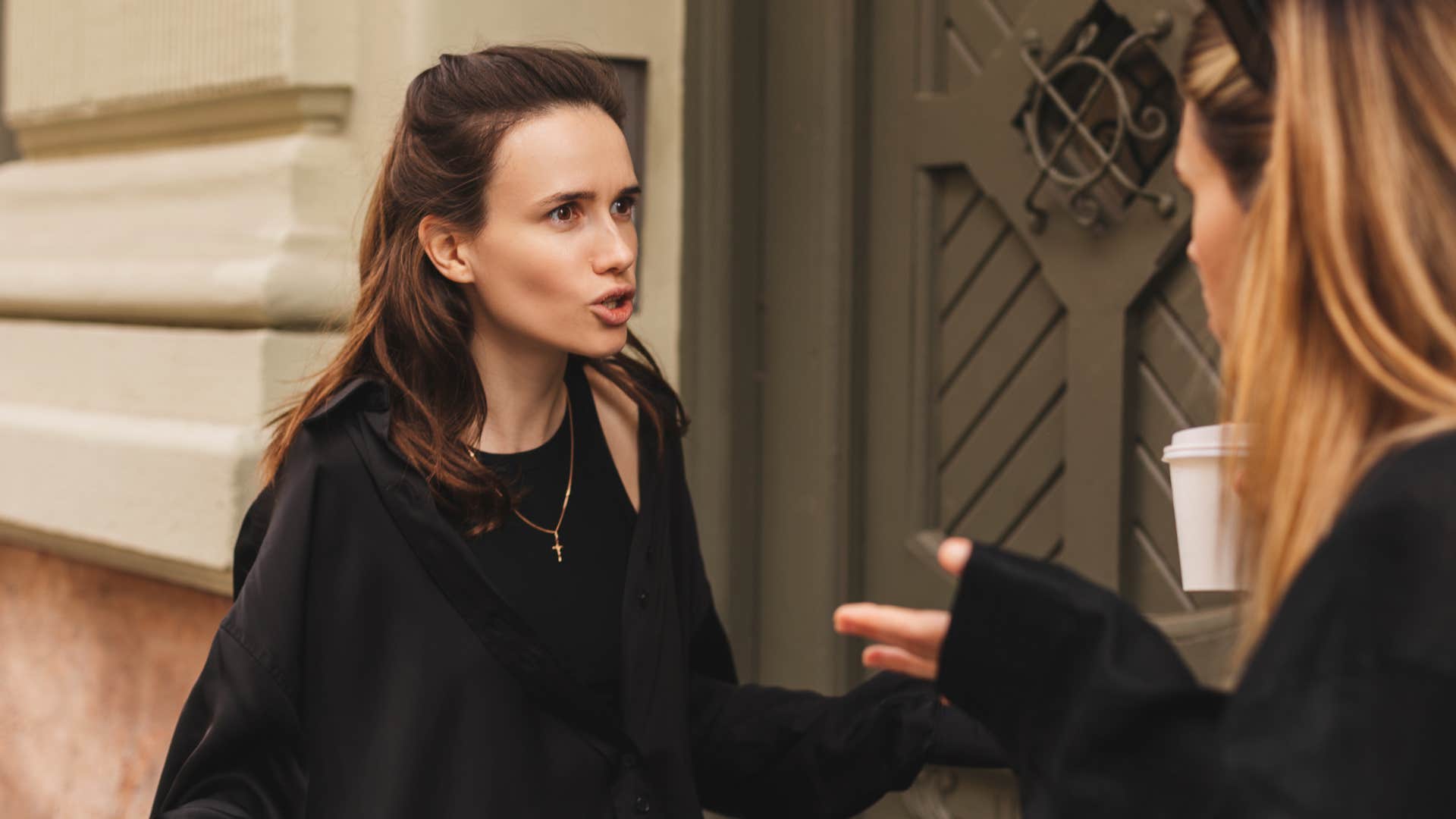 Woman giving backhanded compliments to her friend.