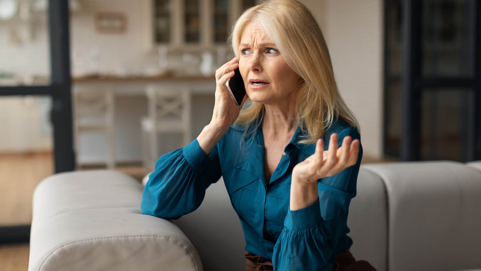 Woman gatekeeping while talking on the phone.