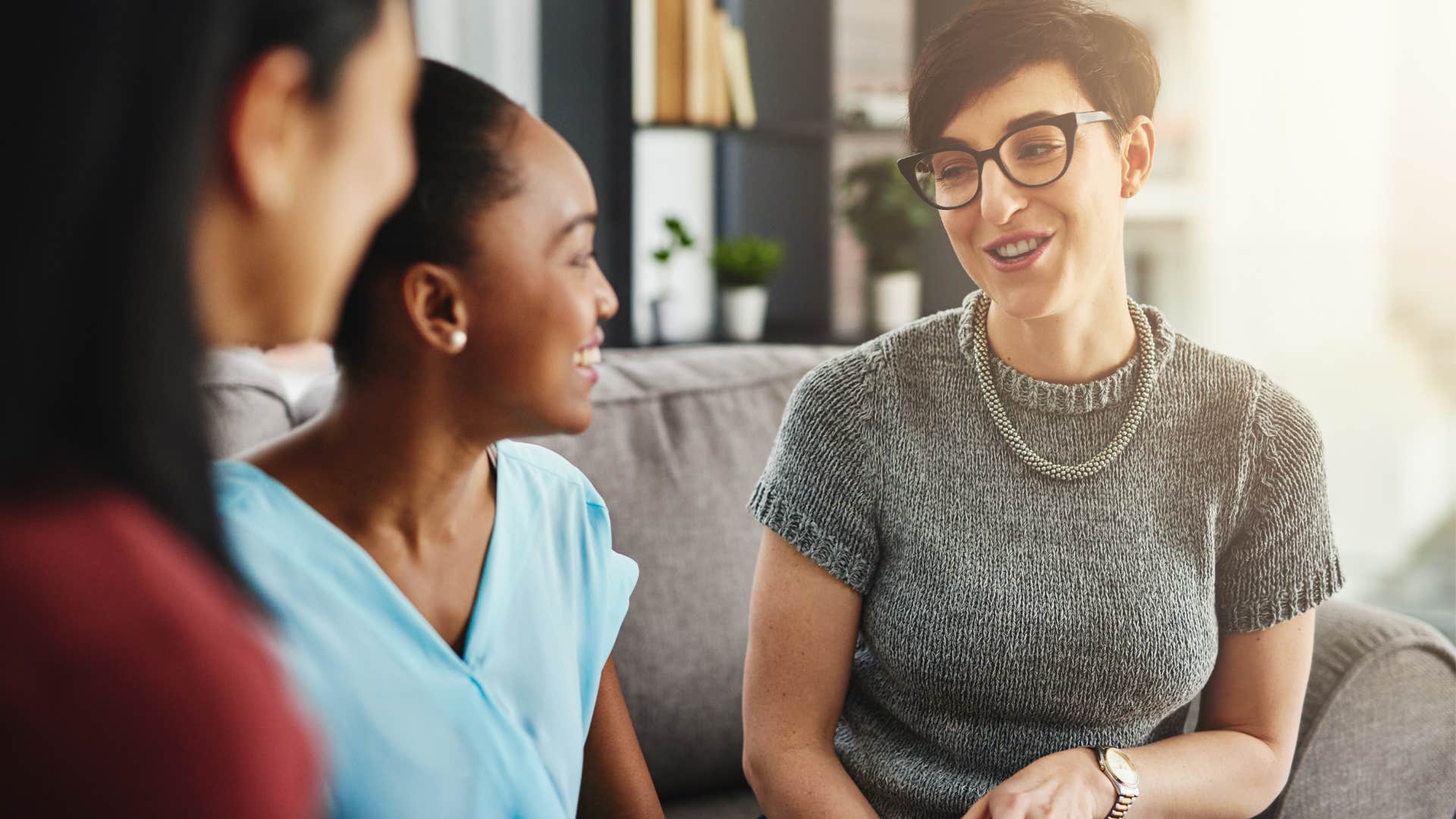 Woman who only praises people in public smiling at friends.