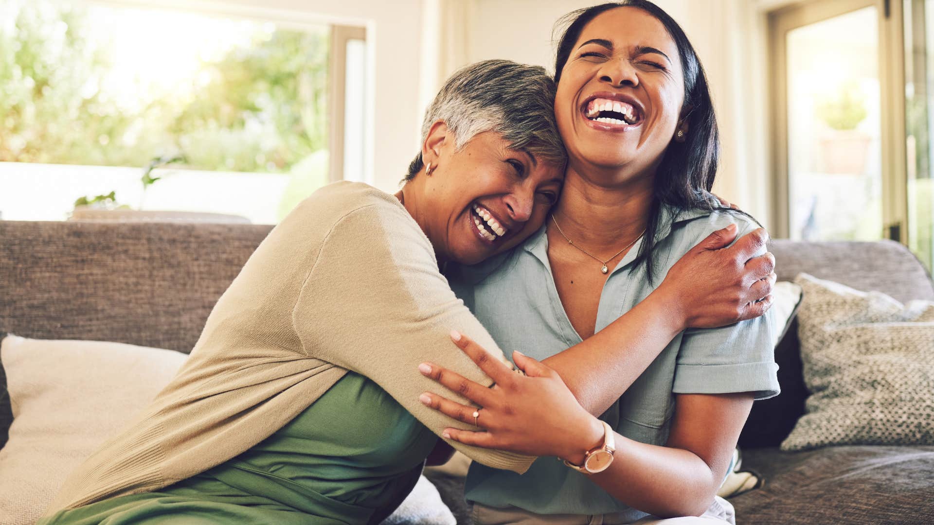 woman smiling and hugging a friend whose presence is energizing