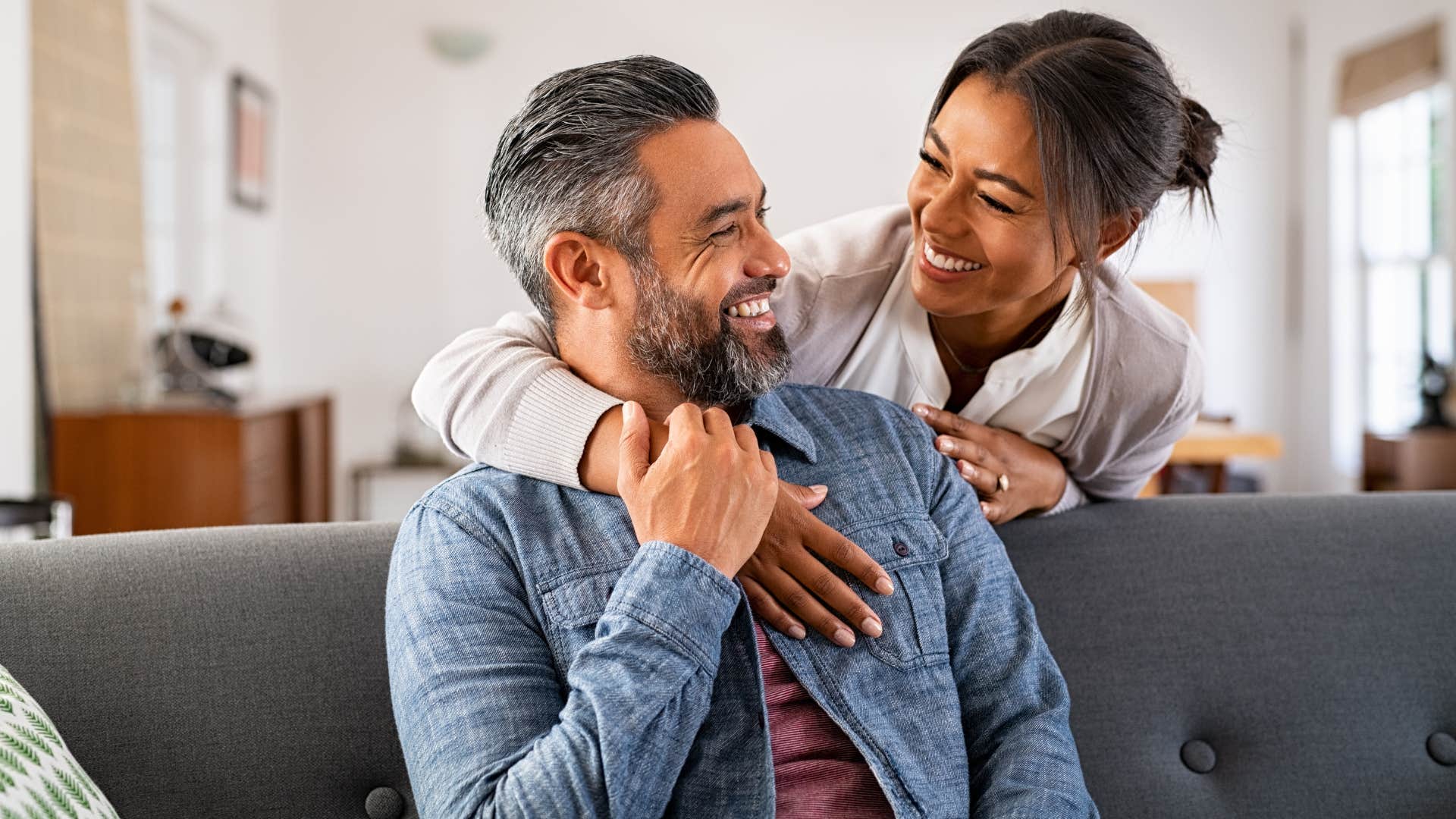 man who doesn't weaponize affection hugging his wife