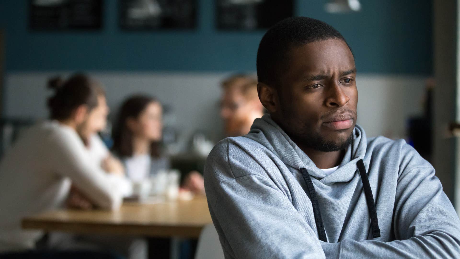 man isolating himself away from friends